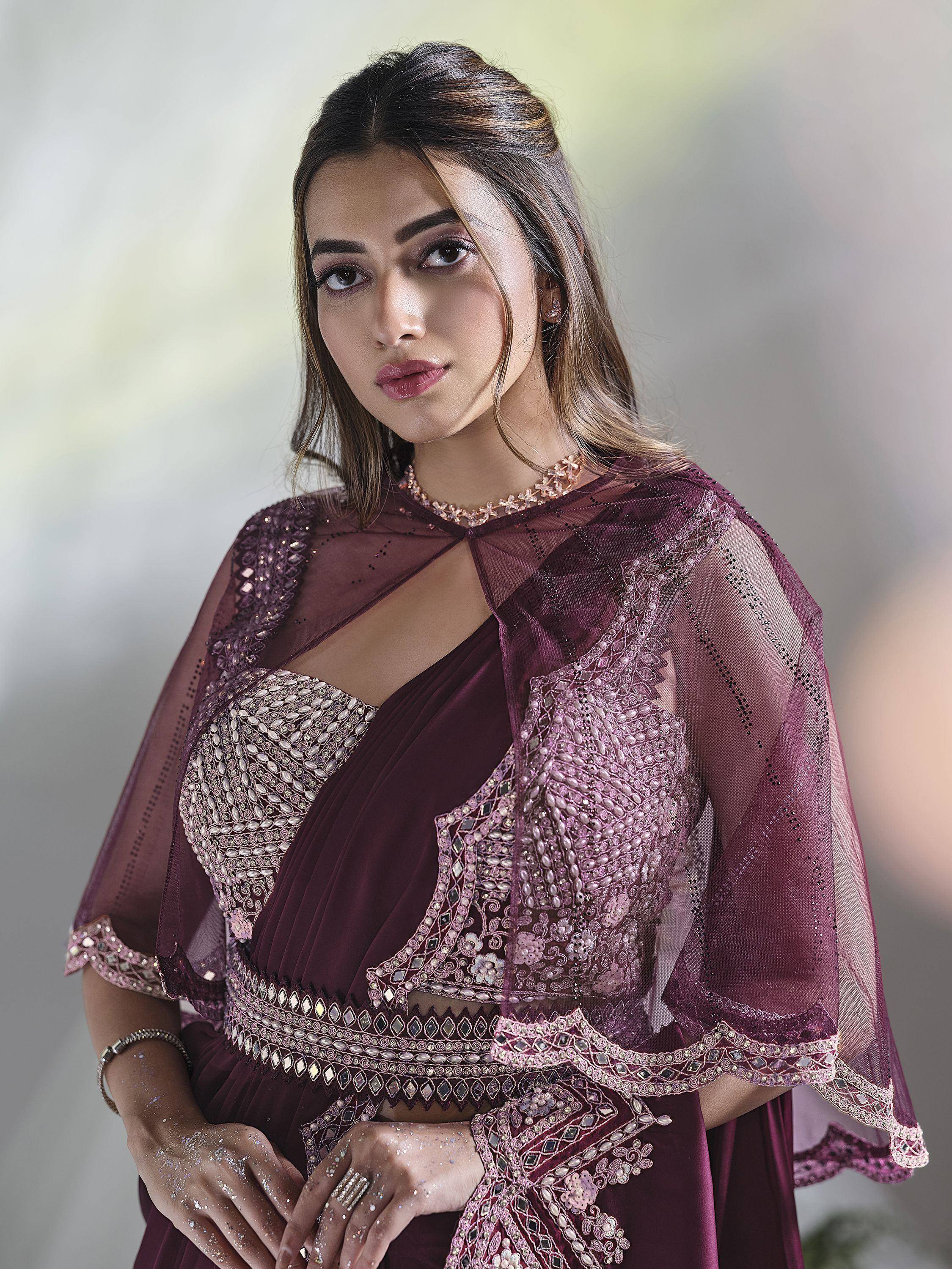 Elegant maroon ethnic gown with sheer cape and intricate embroidery for Indian occasions
