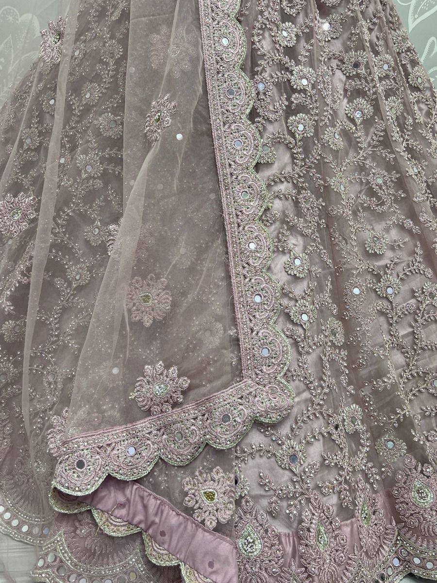Elegant mauve lehenga choli with intricate floral embroidery and mirror work, perfect for Indian ethnic wear.