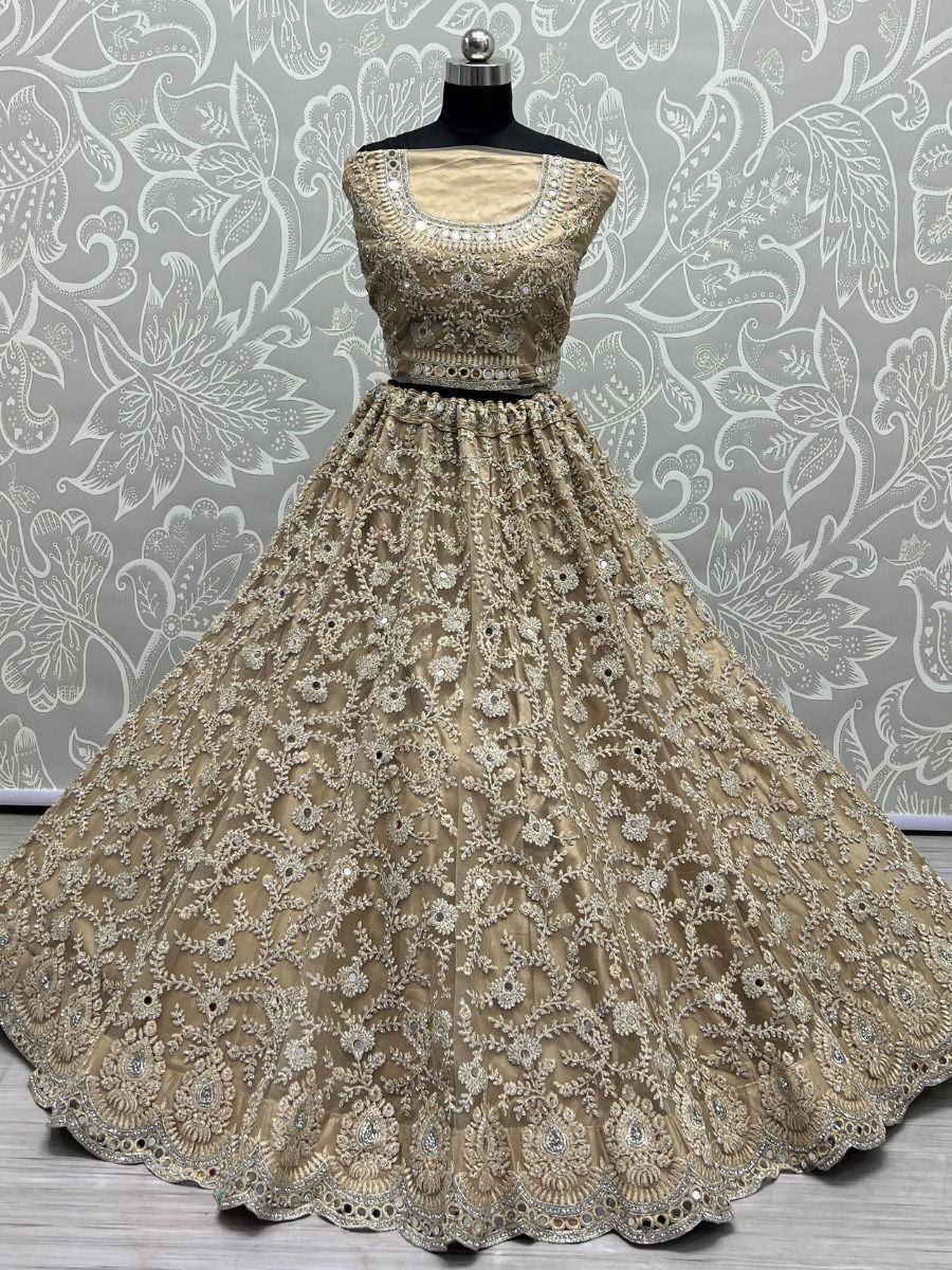 Beige designer lehenga choli with heavy embroidery and mirror work, perfect for Indian weddings and festivals
