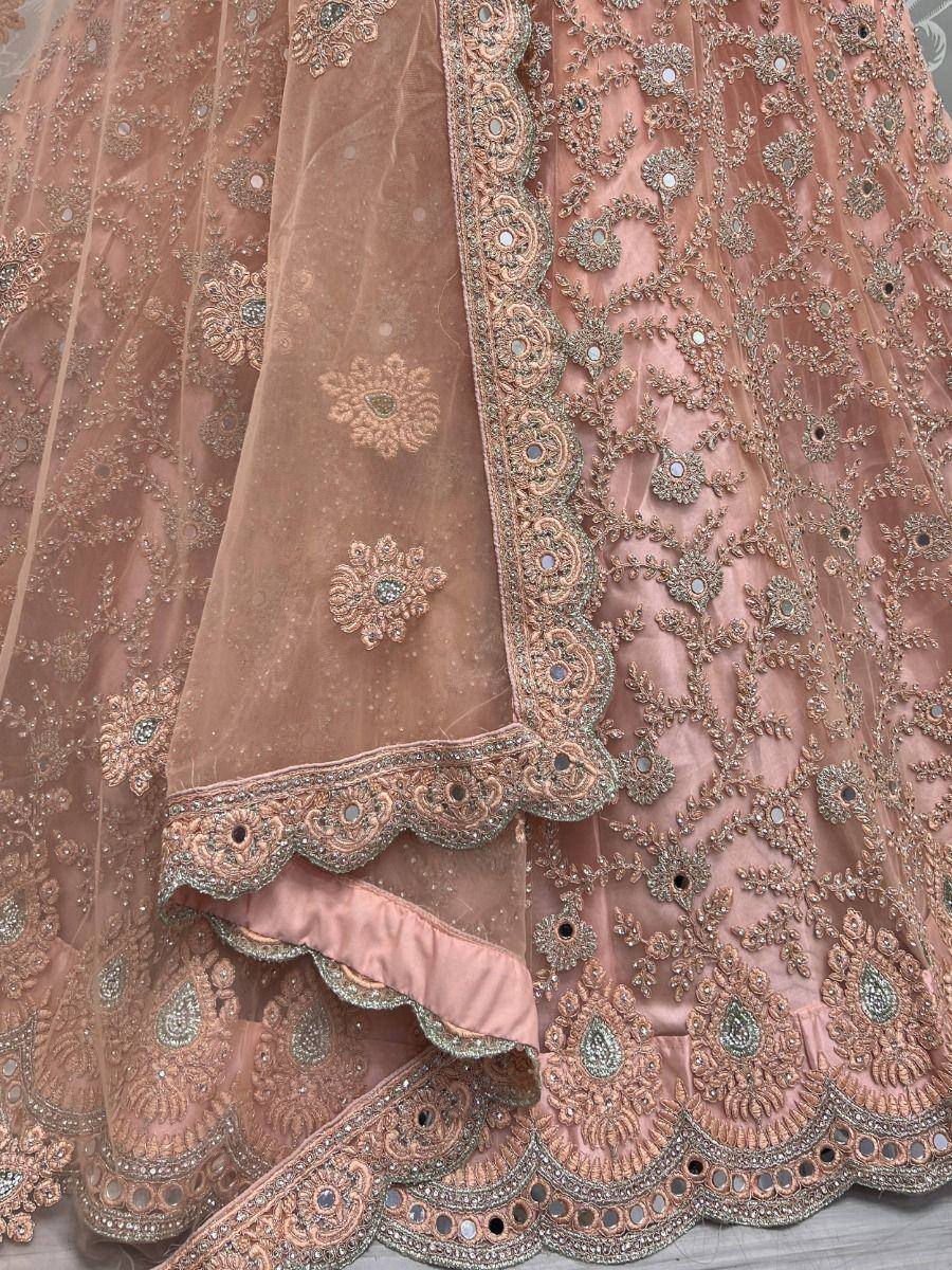 Pink designer lehenga with intricate gold embroidery and mirror work, perfect for Indian weddings
