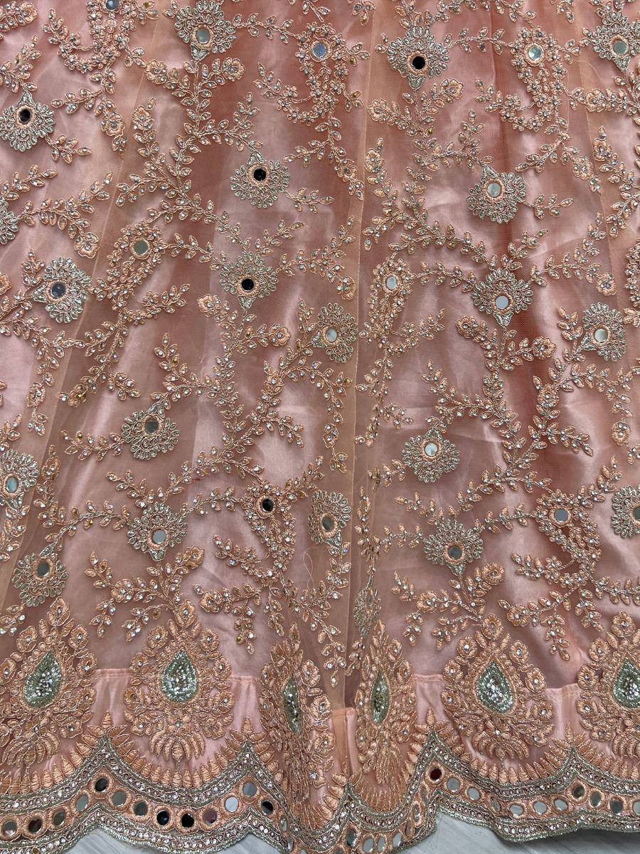 Pink designer lehenga with intricate gold embroidery and mirror work, perfect for Indian ethnic wear
