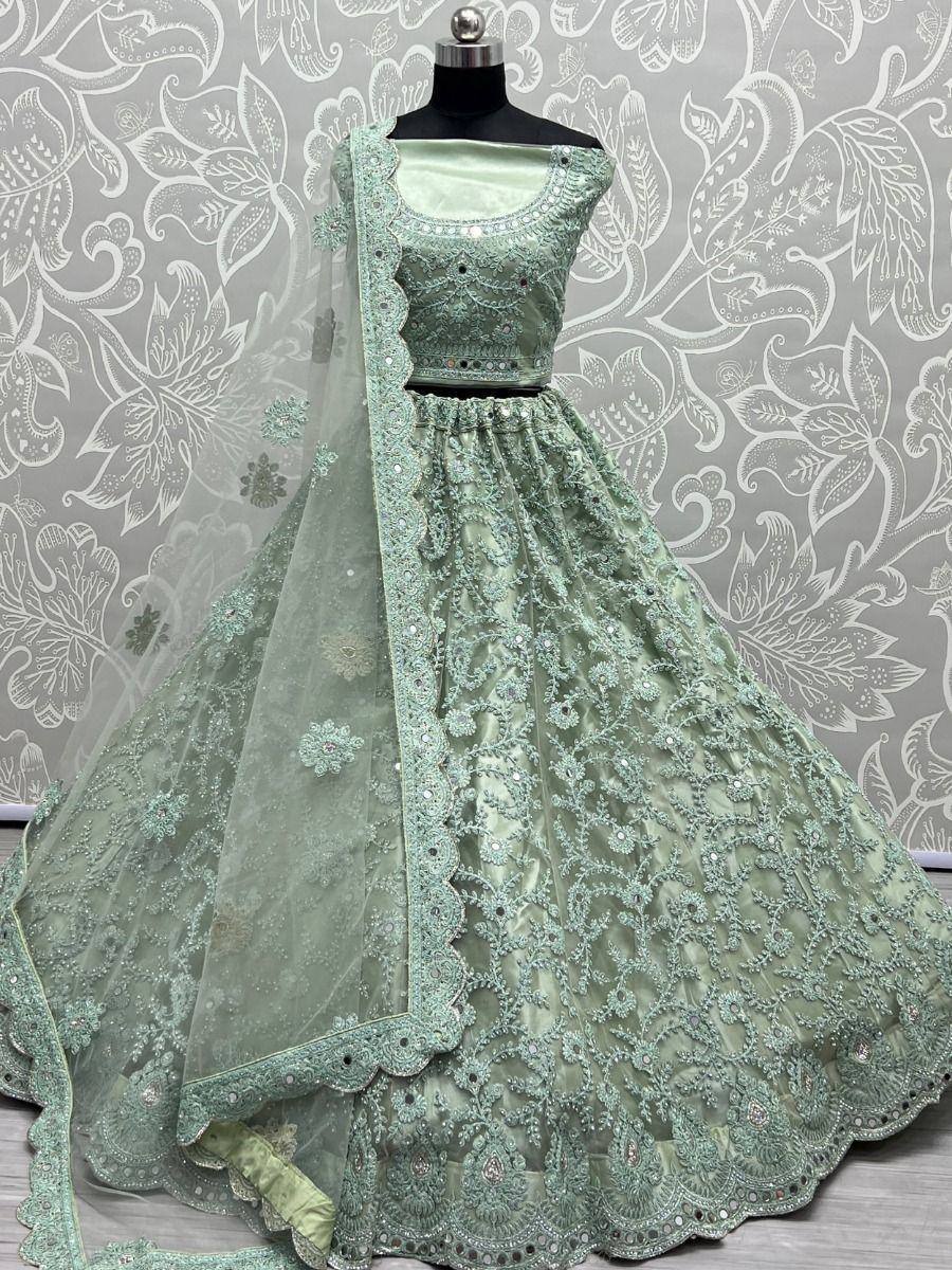 Mint green designer lehenga choli with intricate embroidery and net dupatta, perfect for weddings and festive occasions.