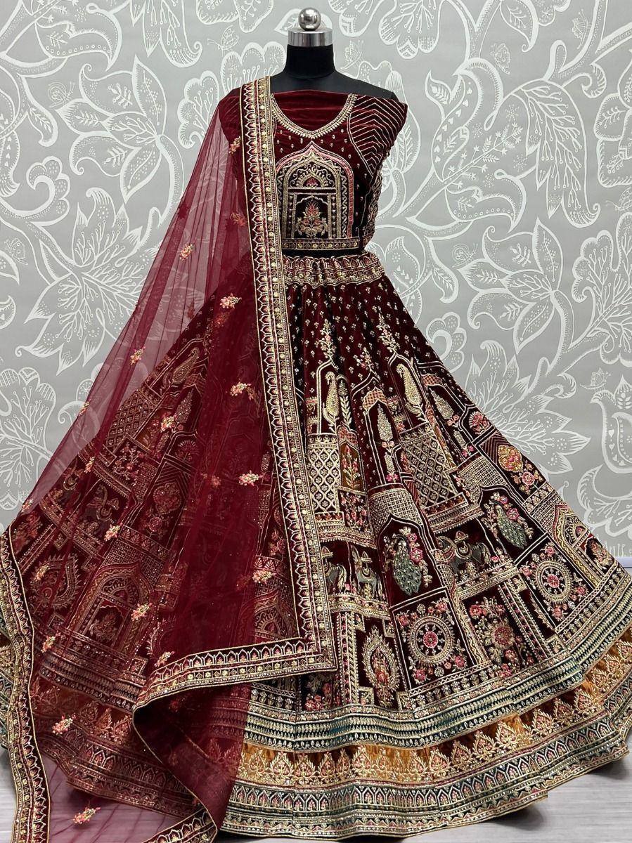Maroon velvet lehenga choli with intricate gold embroidery and sheer dupatta, perfect for Indian weddings