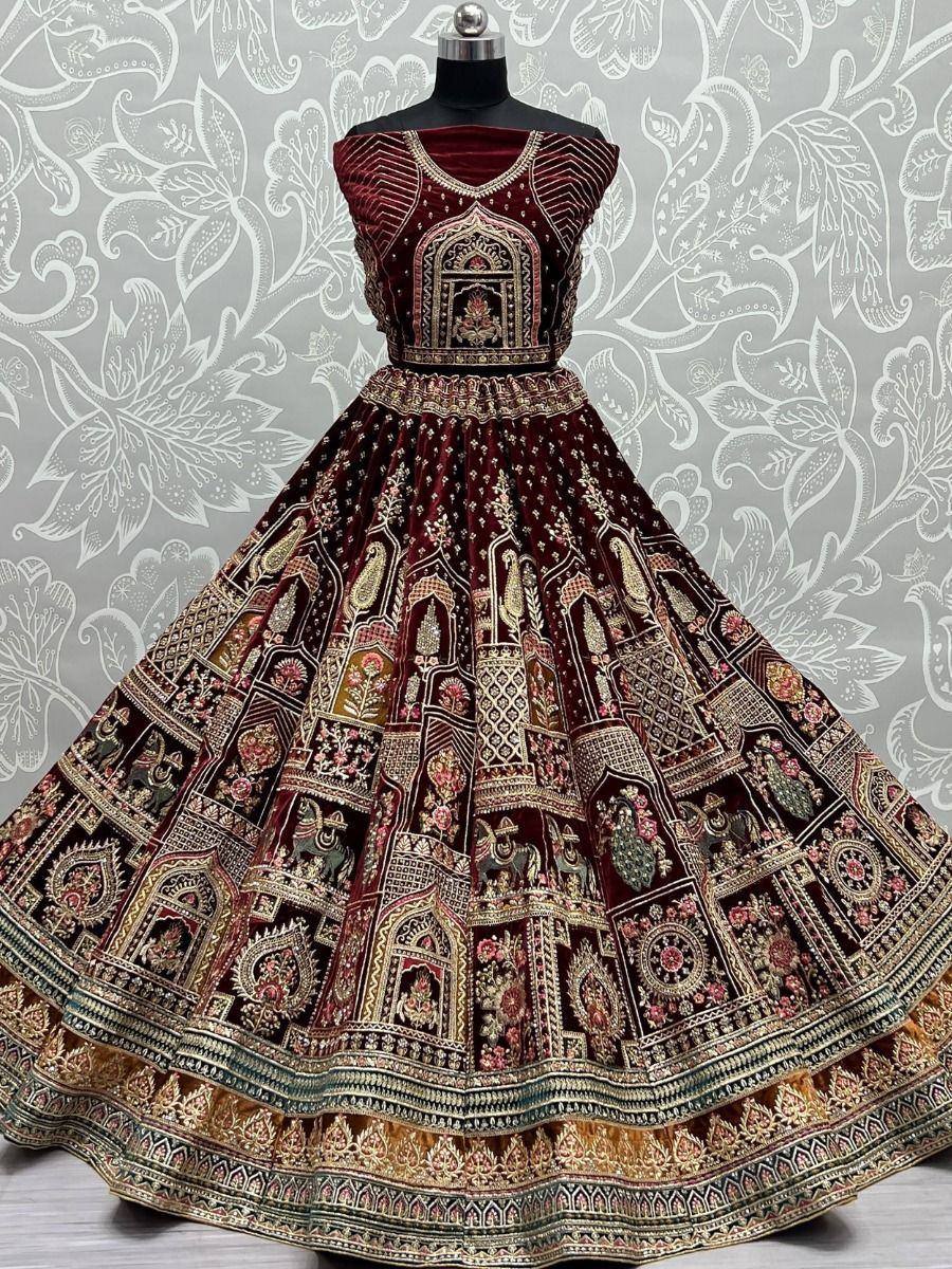 Maroon velvet lehenga choli with intricate gold embroidery and temple motifs, perfect for Indian ethnic wear.