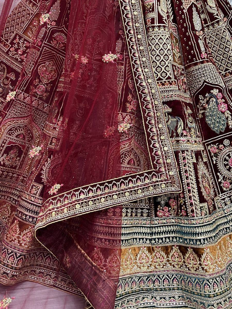 Luxury maroon lehenga choli with intricate gold embroidery and peacock motifs, perfect for Indian weddings.