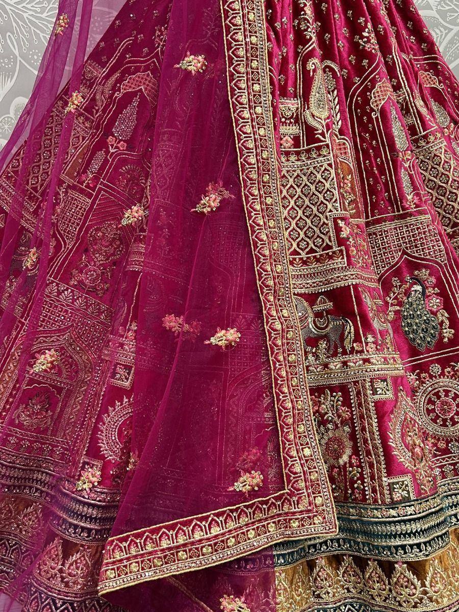Rich maroon velvet lehenga with gold embroidery, peacock & elephant motifs, perfect for Indian weddings