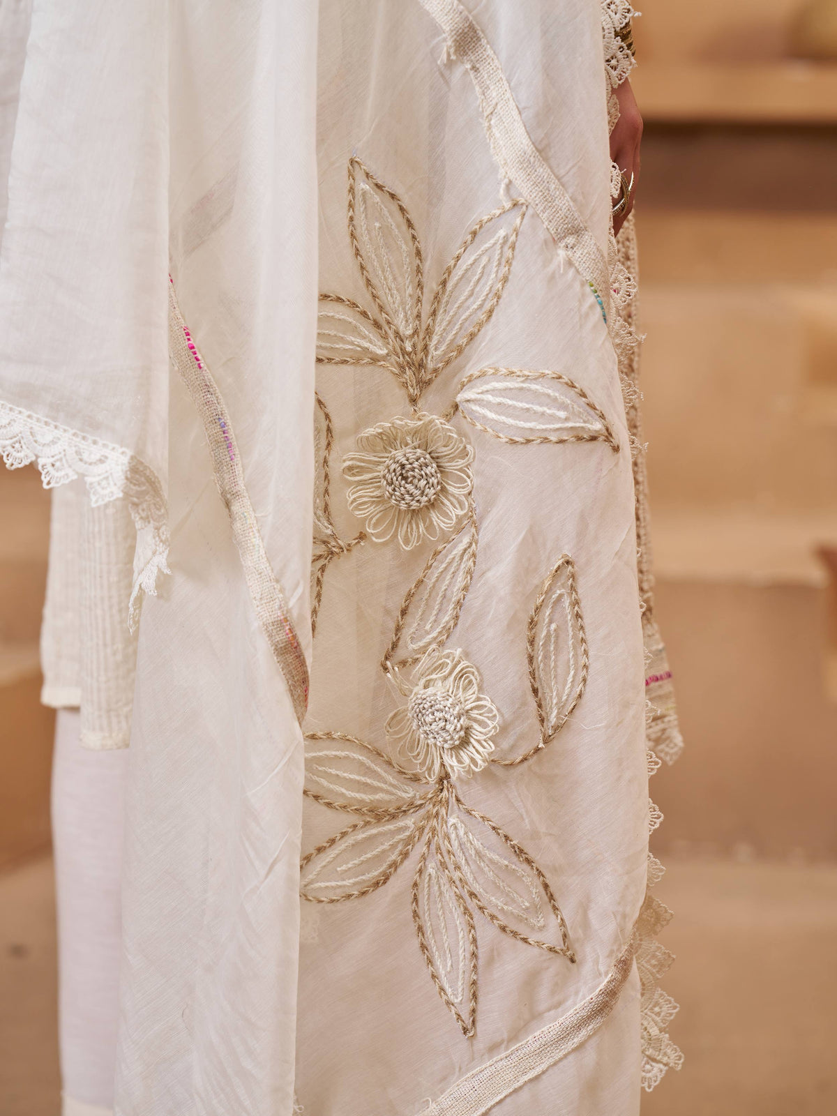 Elegant white ethnic gown with floral embroidery and lace detailing