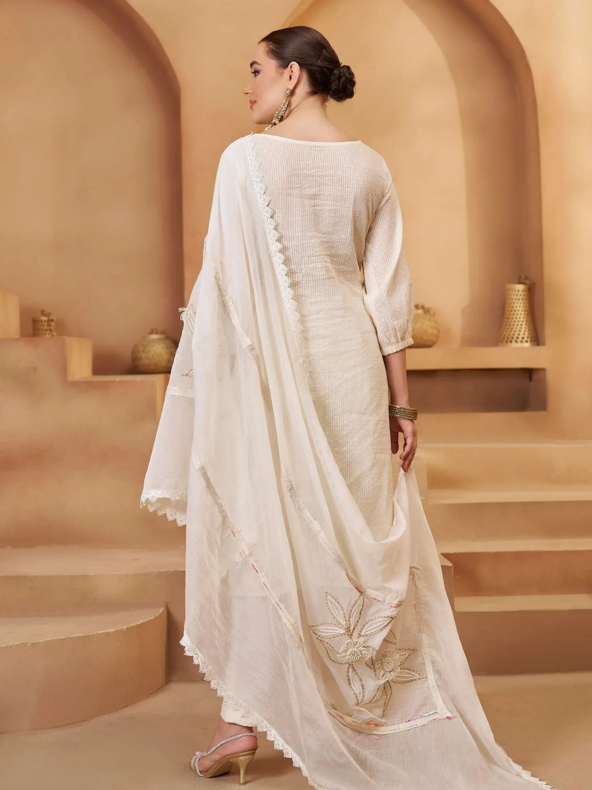 Elegant white ethnic gown with floral embroidery and lace detailing, perfect for Indian occasions