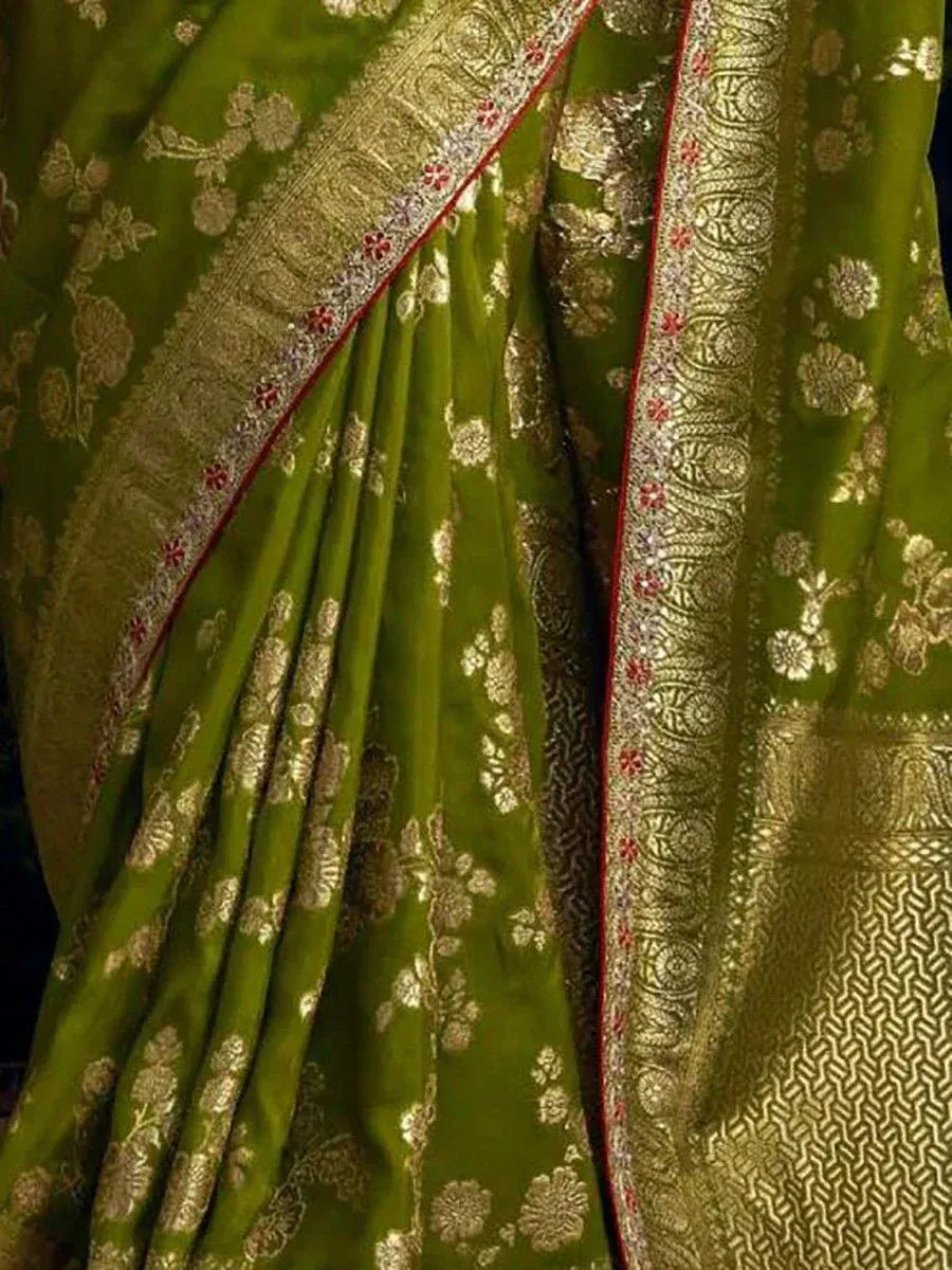 Green designer saree with gold floral embroidery and intricate border detailing for ethnic wear