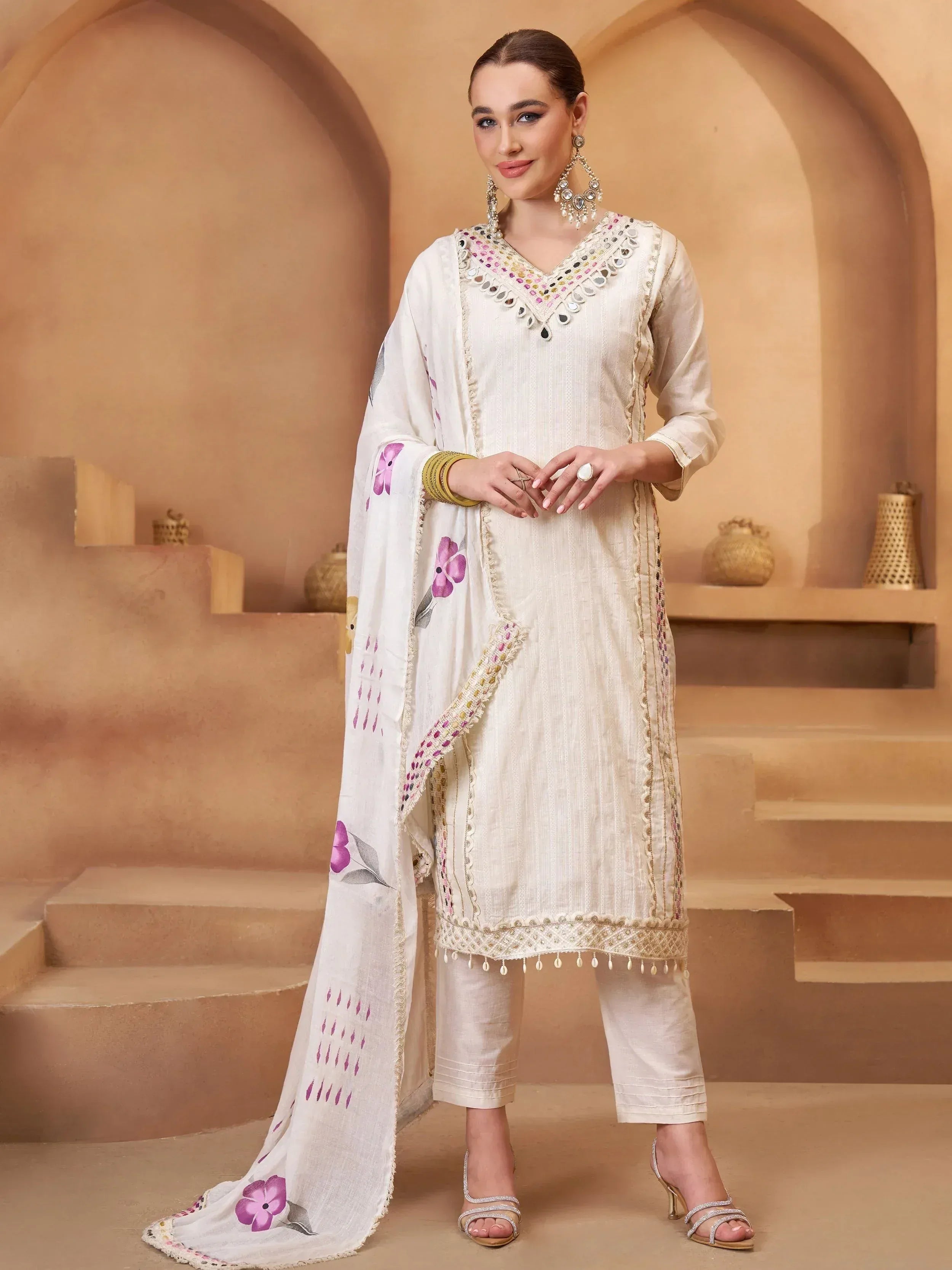White ethnic salwar kameez with mirror work and floral dupatta, perfect for Indian occasions