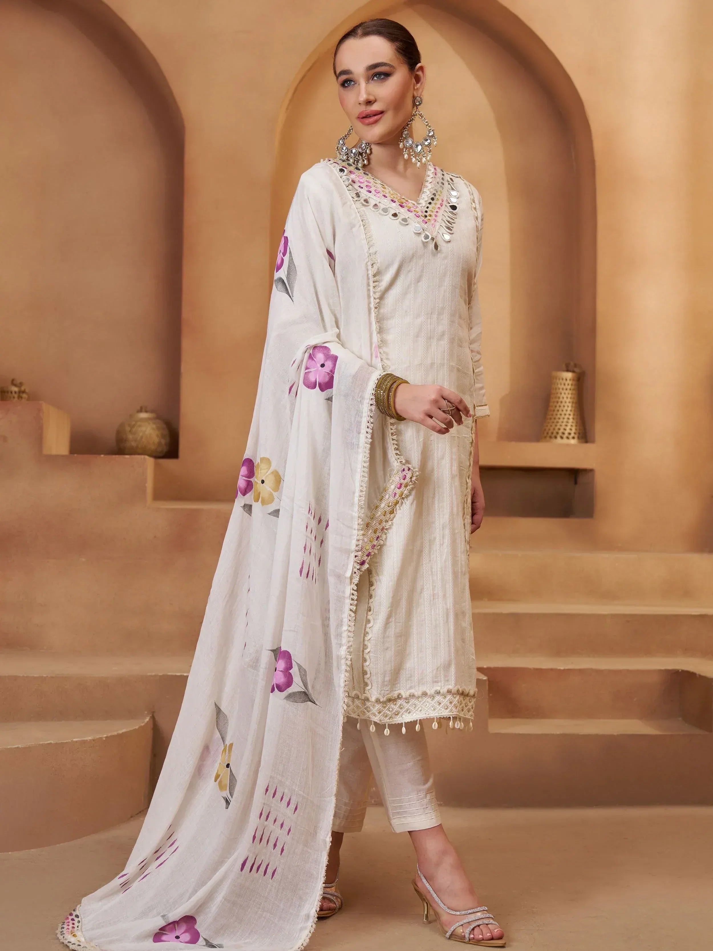 White ethnic salwar kameez with floral dupatta and mirror work, perfect for Indian festive occasions