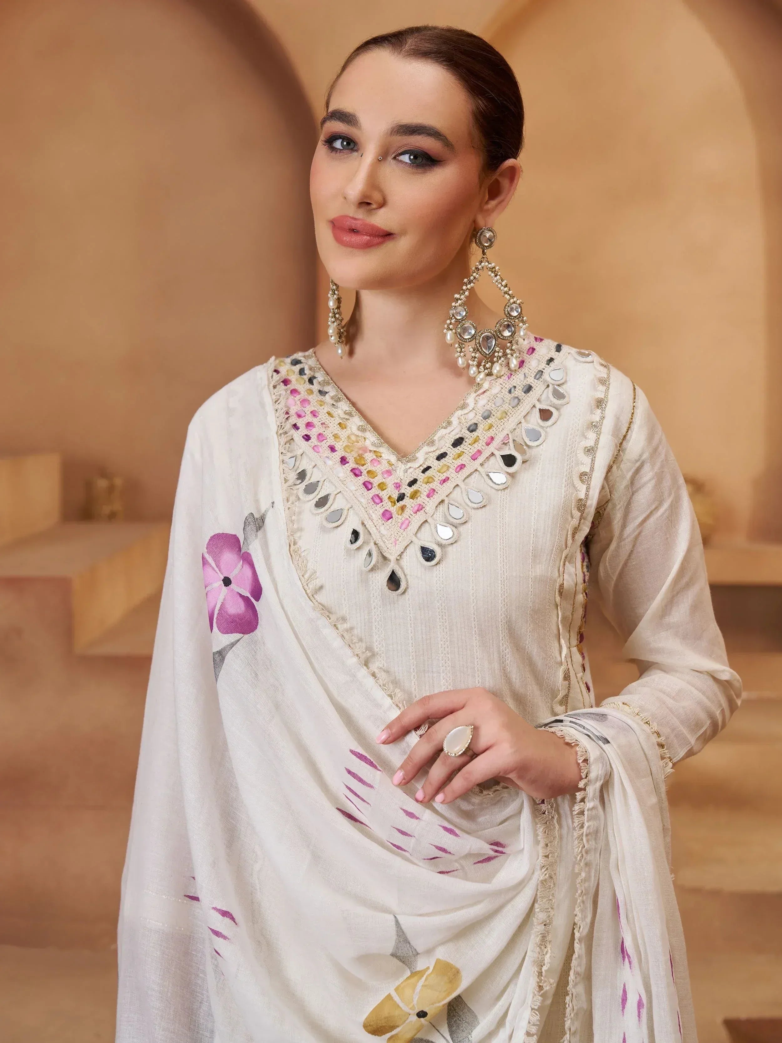 White ethnic salwar kameez with mirror work and floral dupatta, perfect for Indian occasions