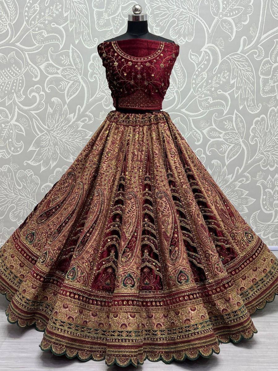Maroon and gold embroidered lehenga choli with intricate paisley design, perfect for Indian ethnic wear occasions.