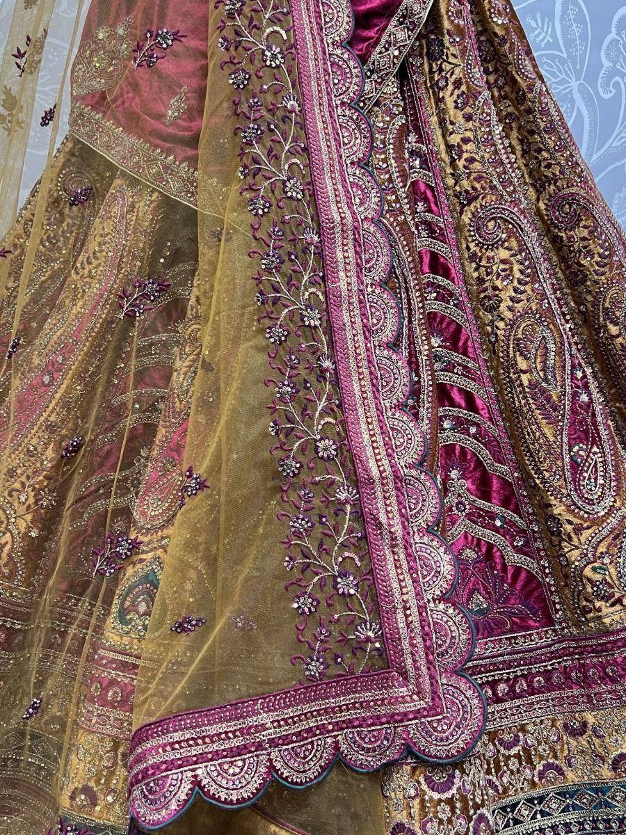 Luxury maroon and gold embroidered lehenga choli with intricate floral and paisley detailing, perfect for weddings.