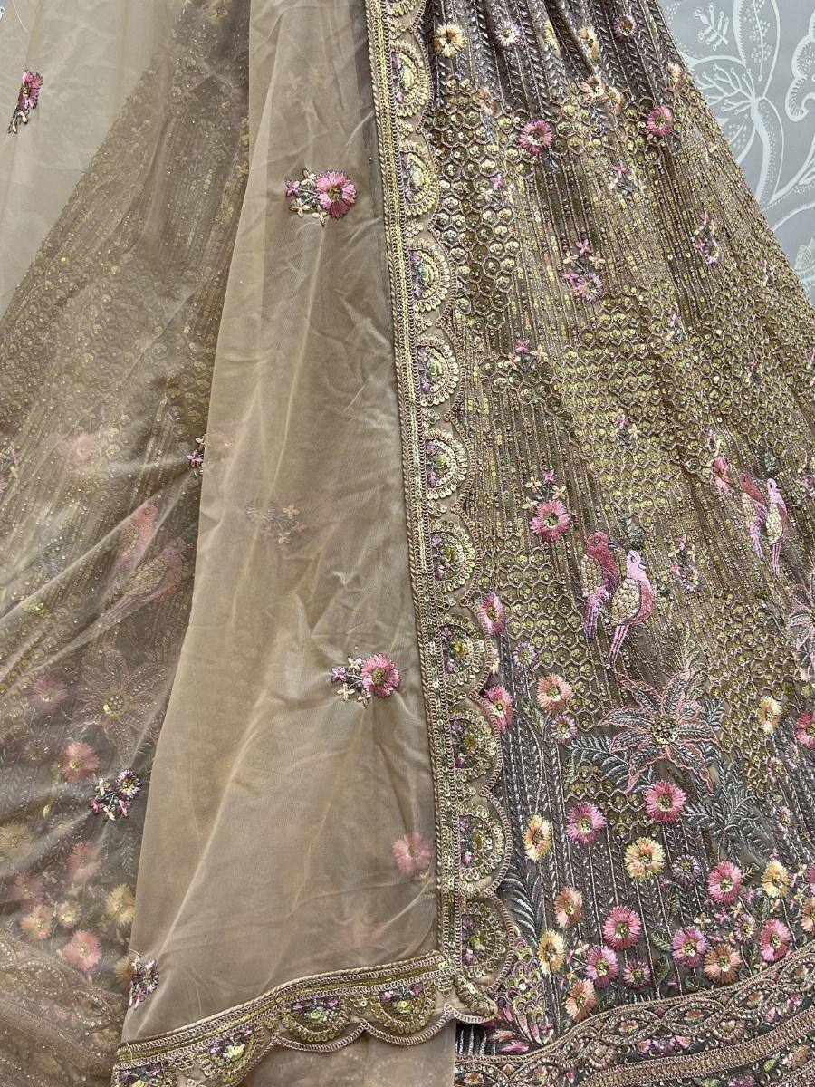 Elegant Indian lehenga with floral and bird embroidery, gold detailing, and sheer dupatta for ethnic wear.