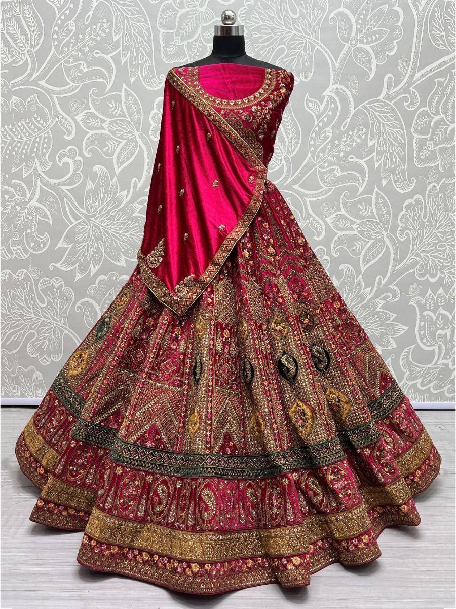 Rich maroon velvet lehenga choli with gold embroidery, perfect for Indian weddings and festive occasions.