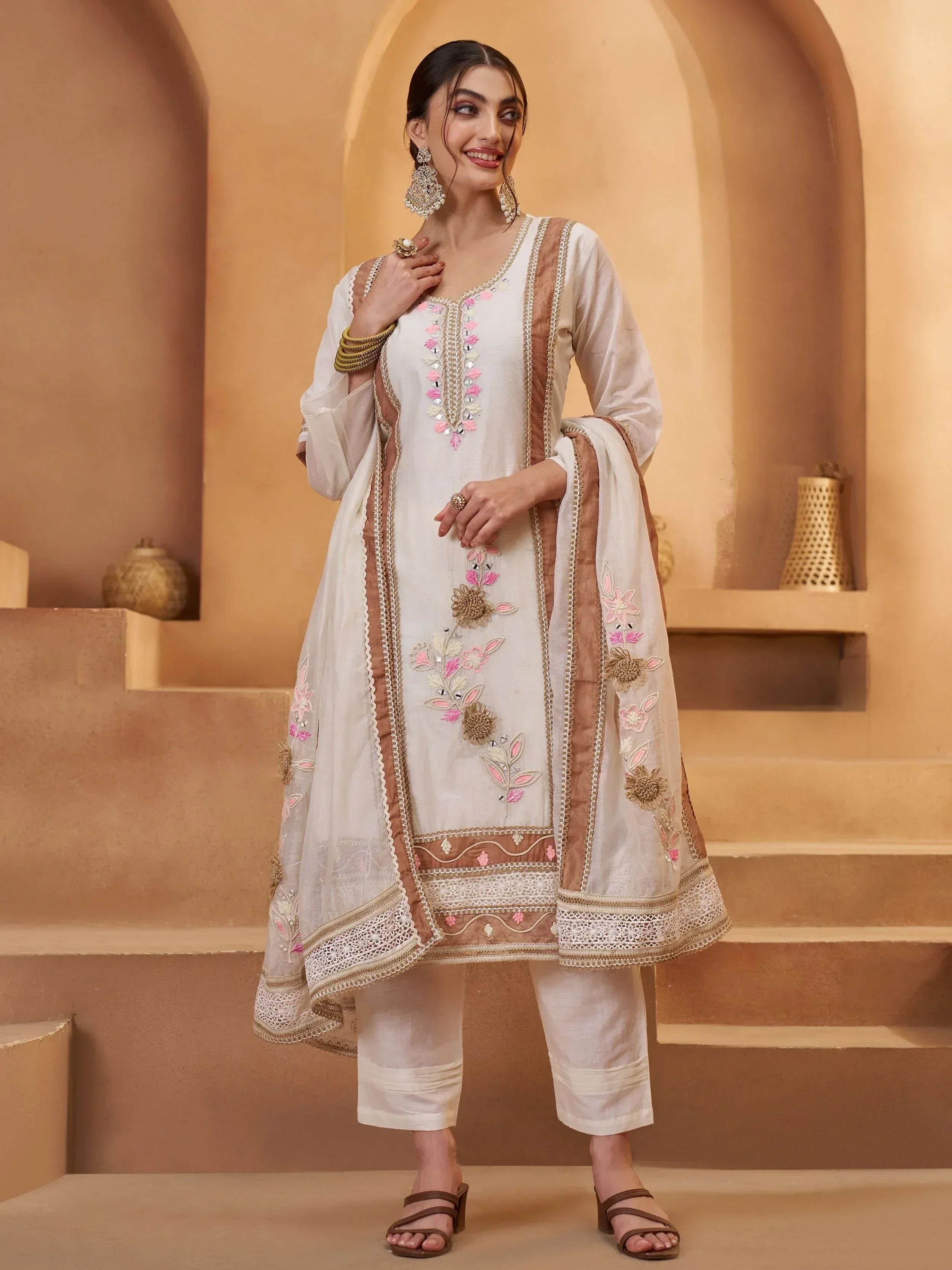 Elegant white salwar kameez with pink floral embroidery and gold detailing, perfect for Indian ethnic wear.