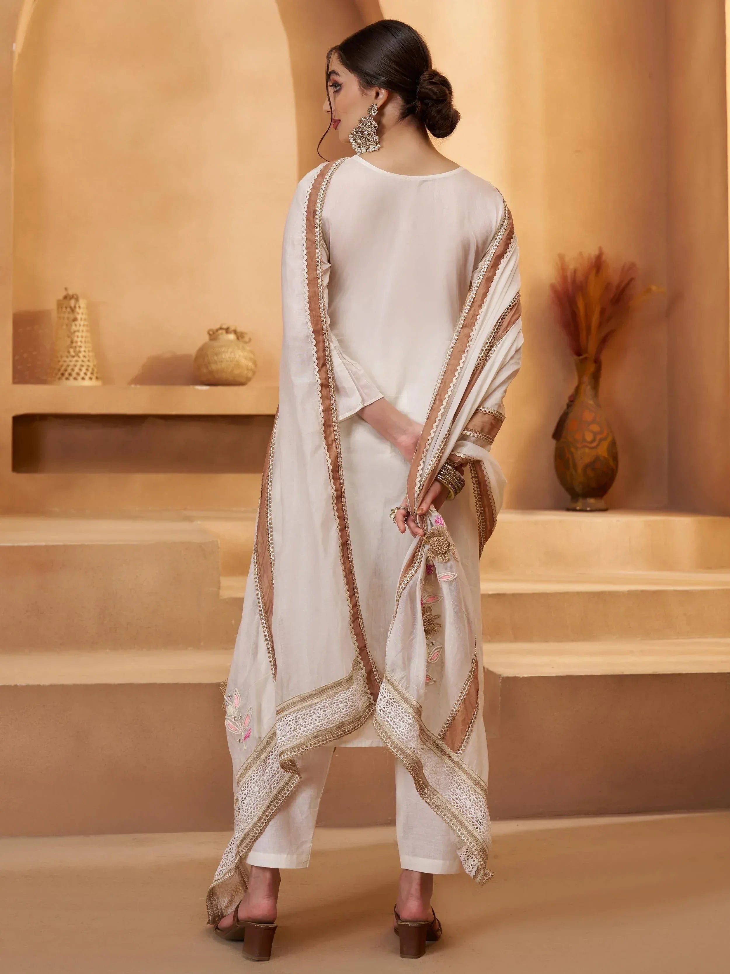 White ethnic salwar kameez with gold embroidery and dupatta, perfect for Indian occasions