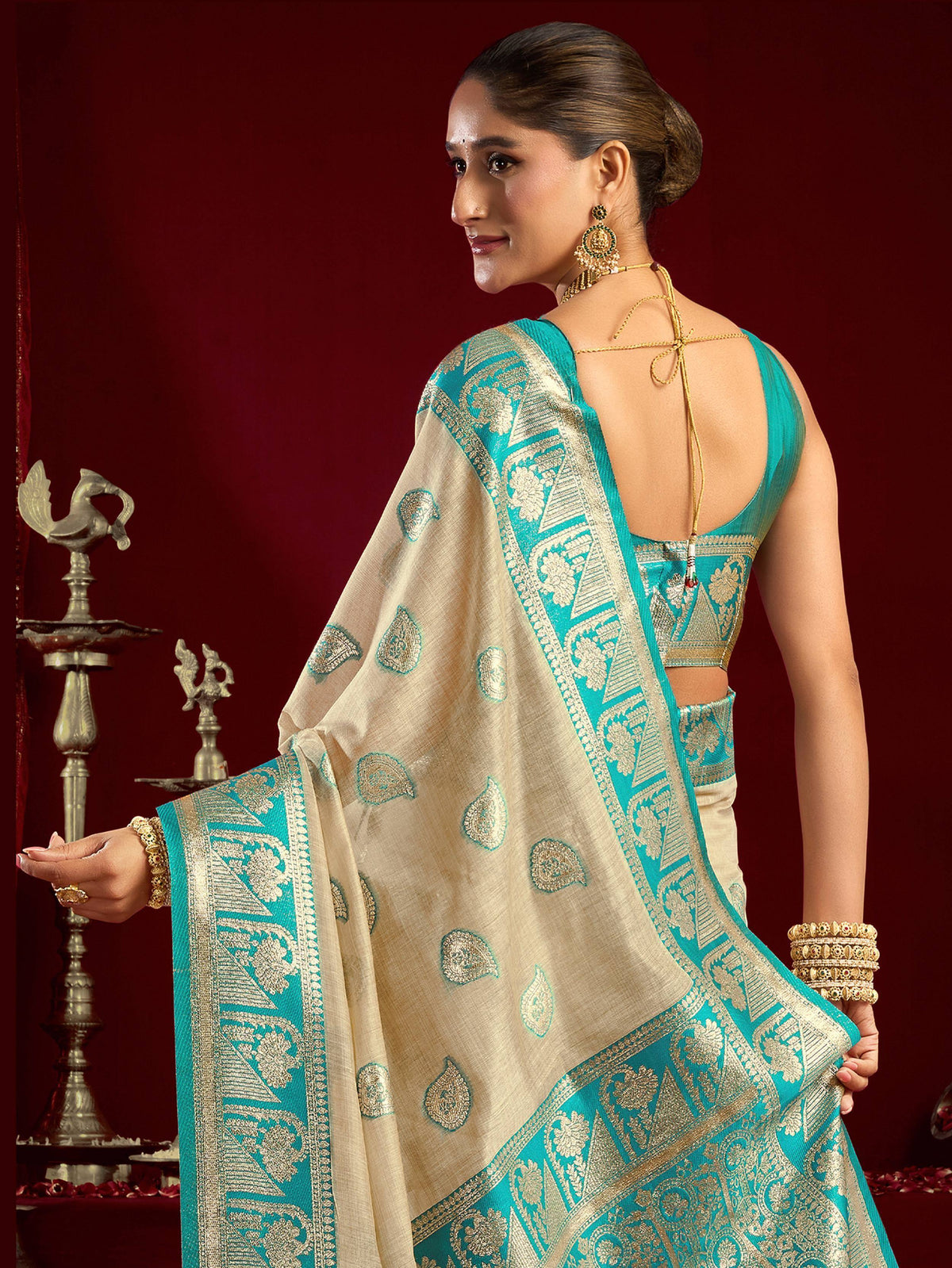 Elegant turquoise and cream designer saree with gold zari work, perfect for Indian ethnic occasions