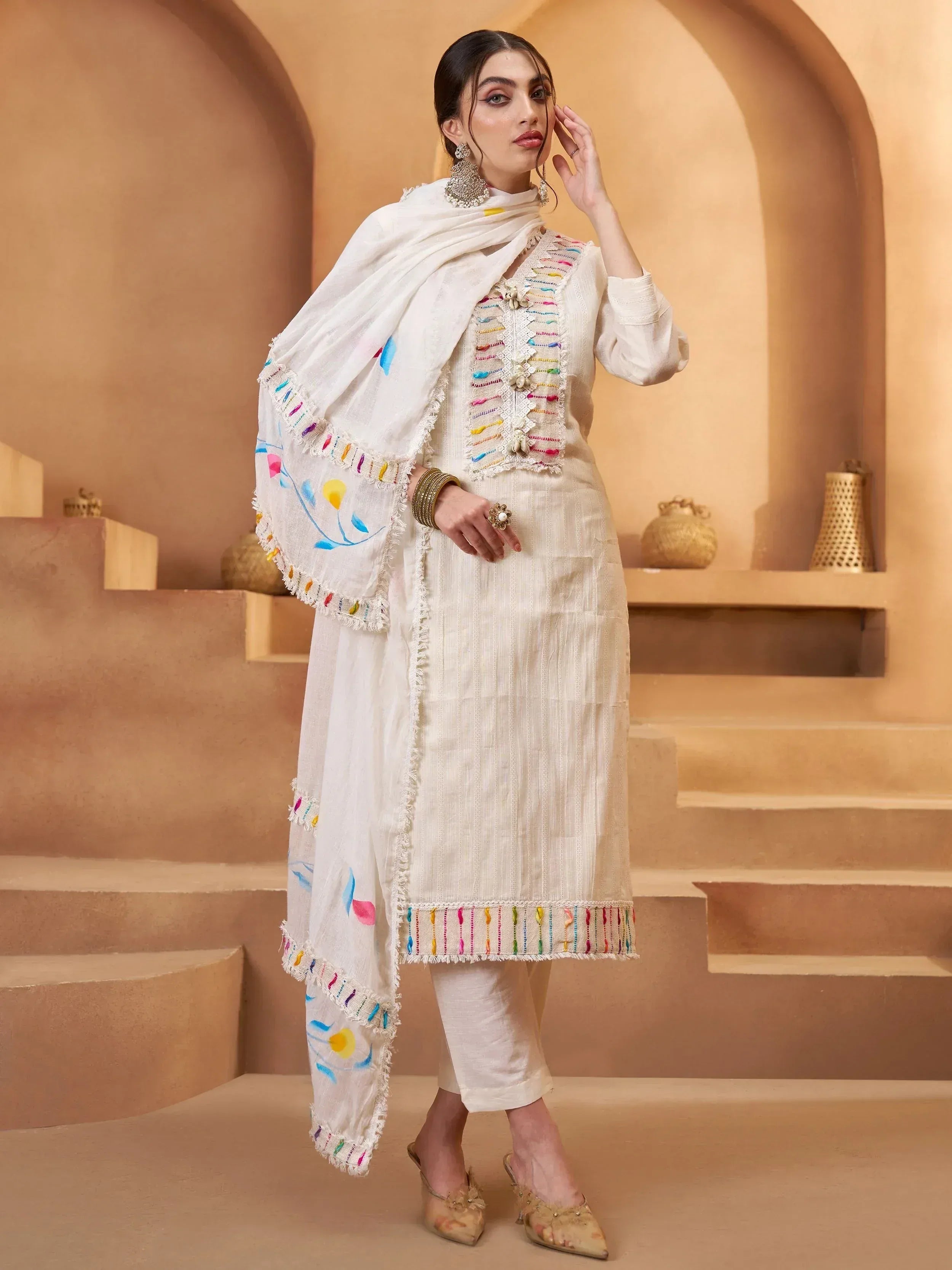 White embroidered salwar kameez with colorful threadwork and floral dupatta, ethnic Indian wear