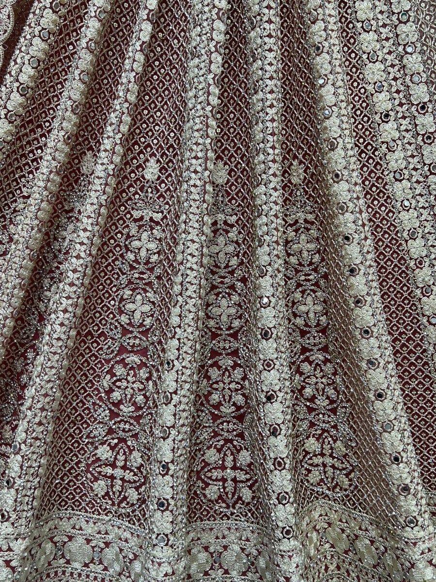 Maroon designer lehenga with intricate silver embroidery and sequin work, perfect for Indian ethnic wear.
