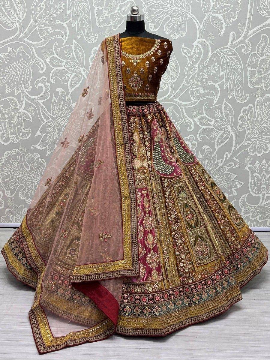 Designer lehenga choli with intricate gold embroidery, maroon and beige panels, and sheer dupatta for Indian ethnic wear