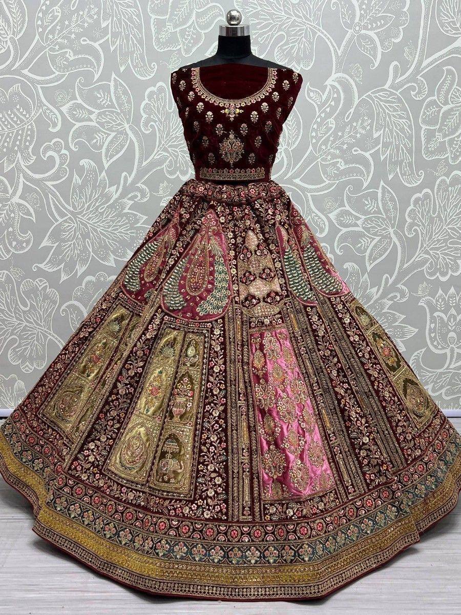 Maroon velvet designer lehenga choli with intricate gold embroidery and colorful panel work, perfect for weddings