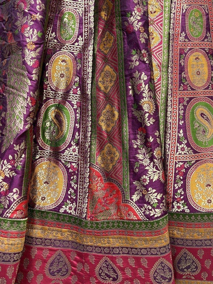 Purple and pink ethnic lehenga with intricate paisley and floral embroidery, perfect for Indian weddings.