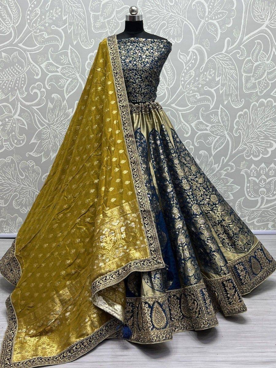 Blue and gold designer lehenga choli with heavy embroidery and matching dupatta, perfect for Indian weddings