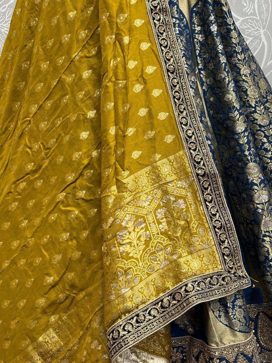 Mustard velvet lehenga with gold floral embroidery and navy blue brocade dupatta, ethnic Indian wear