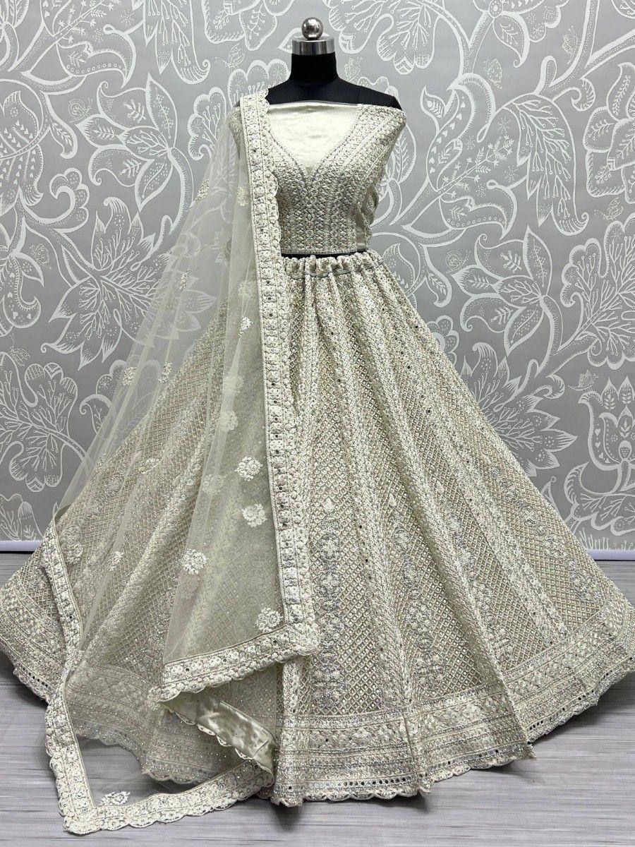 Elegant off-white designer lehenga choli with intricate embroidery and sheer dupatta, perfect for weddings and festive occasions.