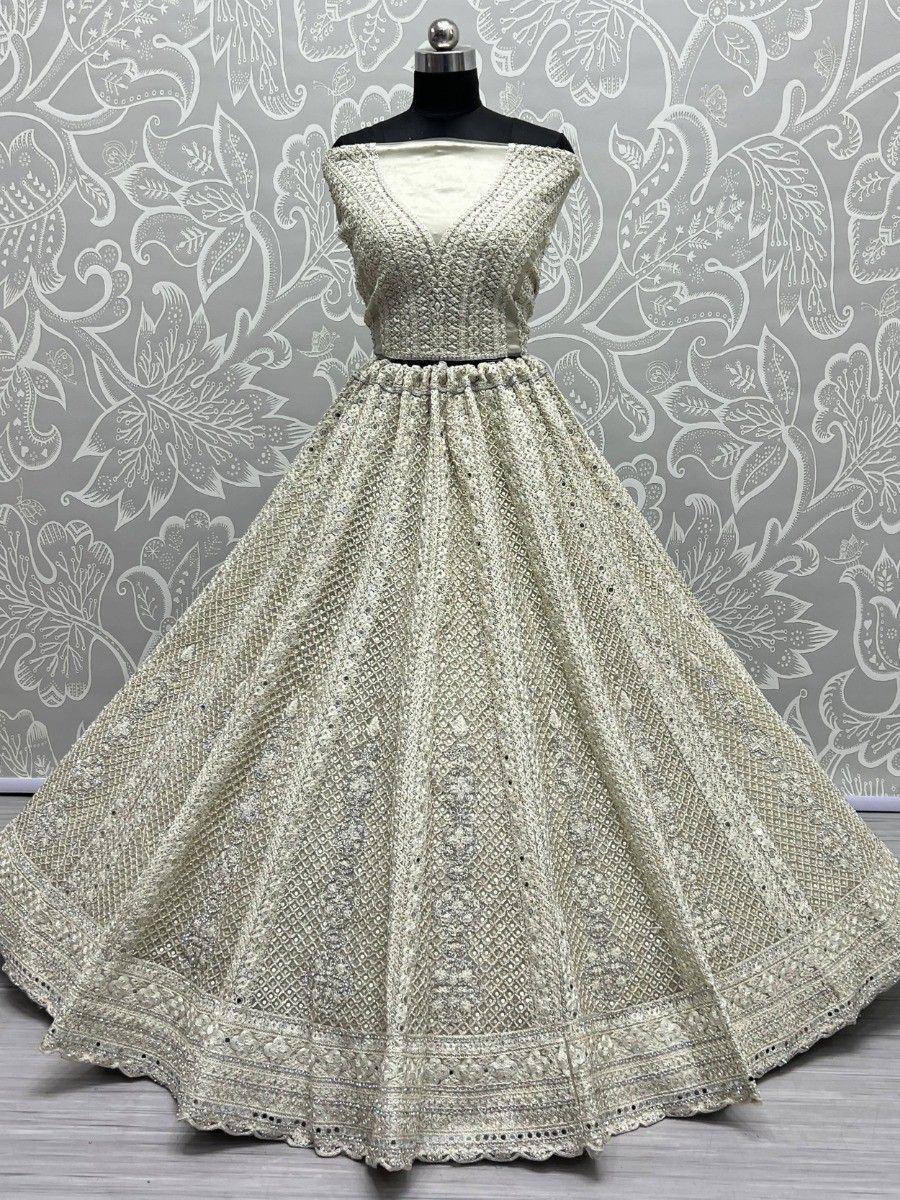 Elegant off-white ethnic gown with intricate embroidery and flared skirt, perfect for Indian celebrations