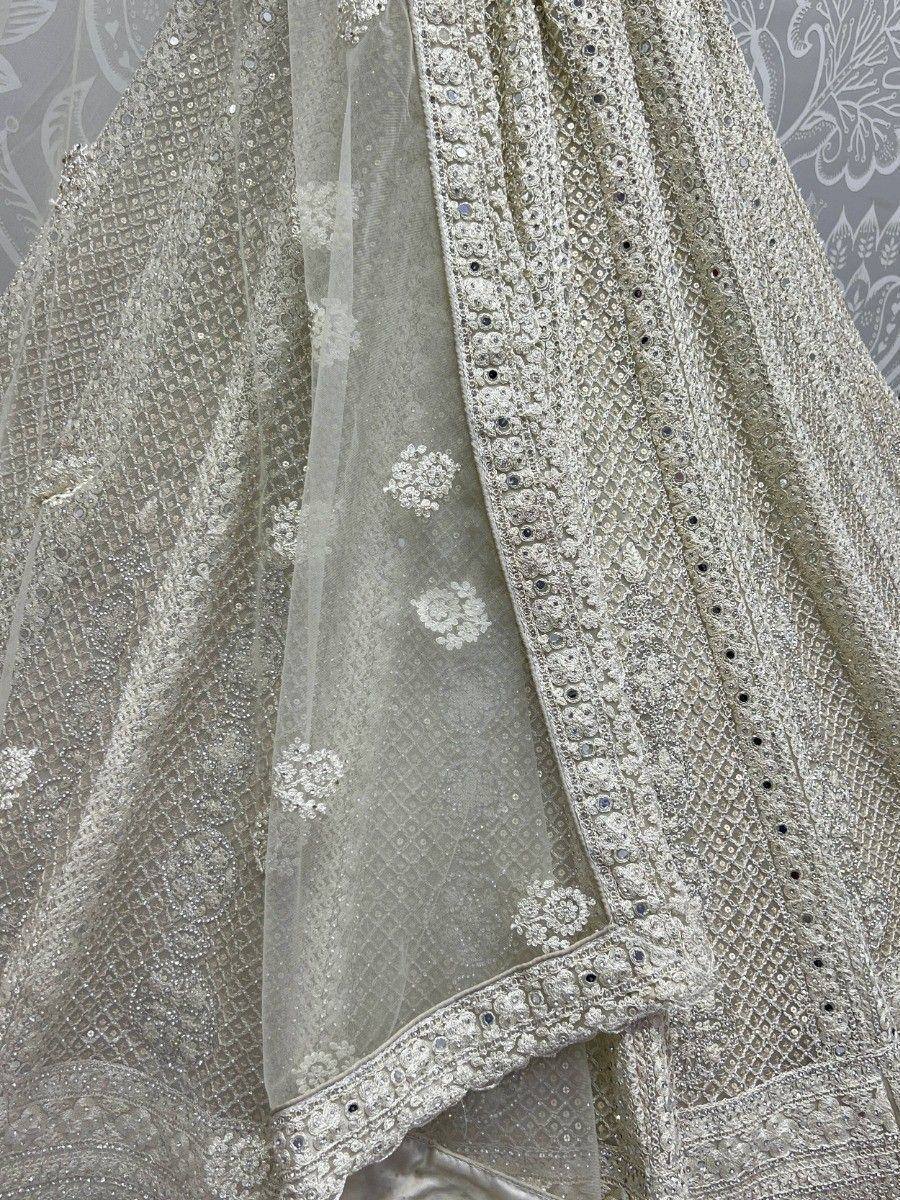Elegant silver ethnic lehenga choli with intricate embroidery and sequin detailing, perfect for weddings