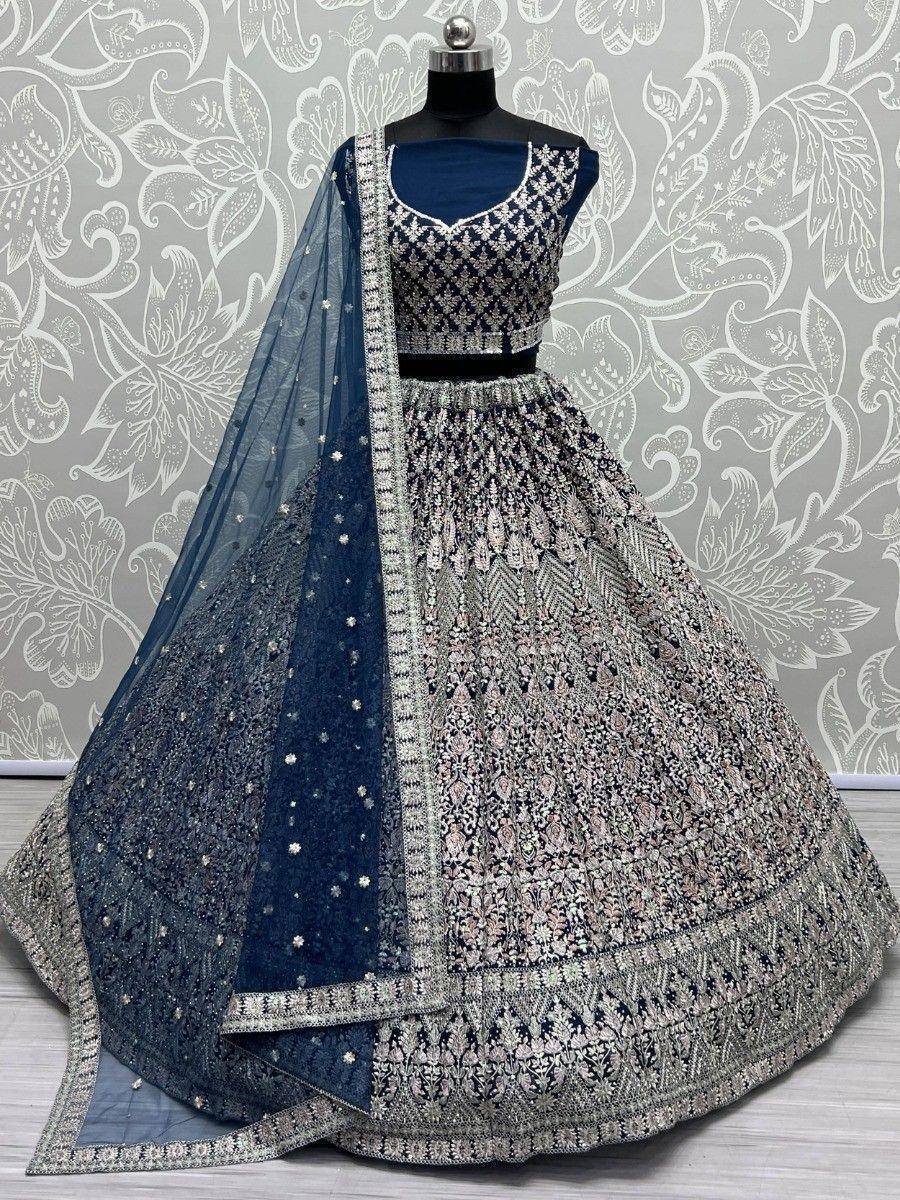 Navy blue designer lehenga choli with intricate embroidery and matching dupatta, perfect for weddings and festive occasions.
