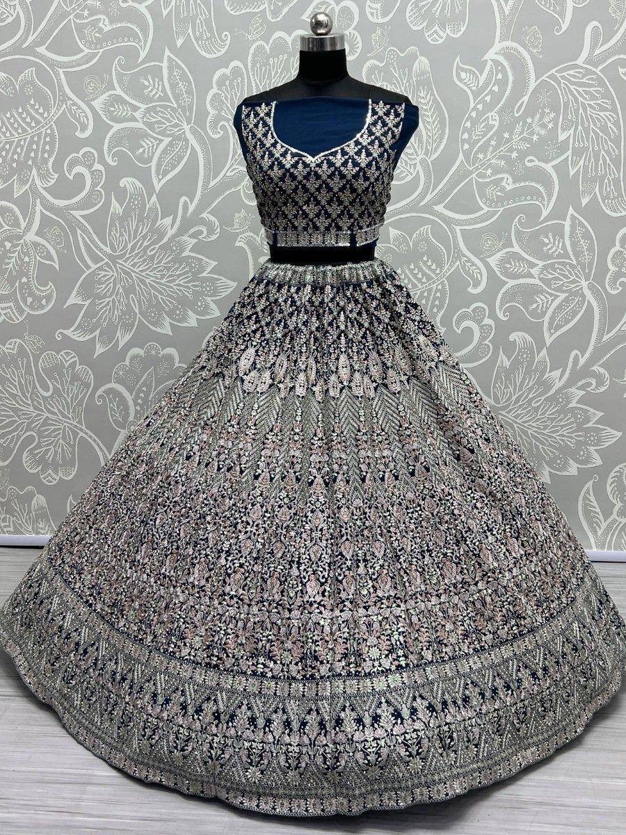 Designer navy blue lehenga choli with intricate silver embroidery and floral patterns, perfect for Indian ethnic wear.