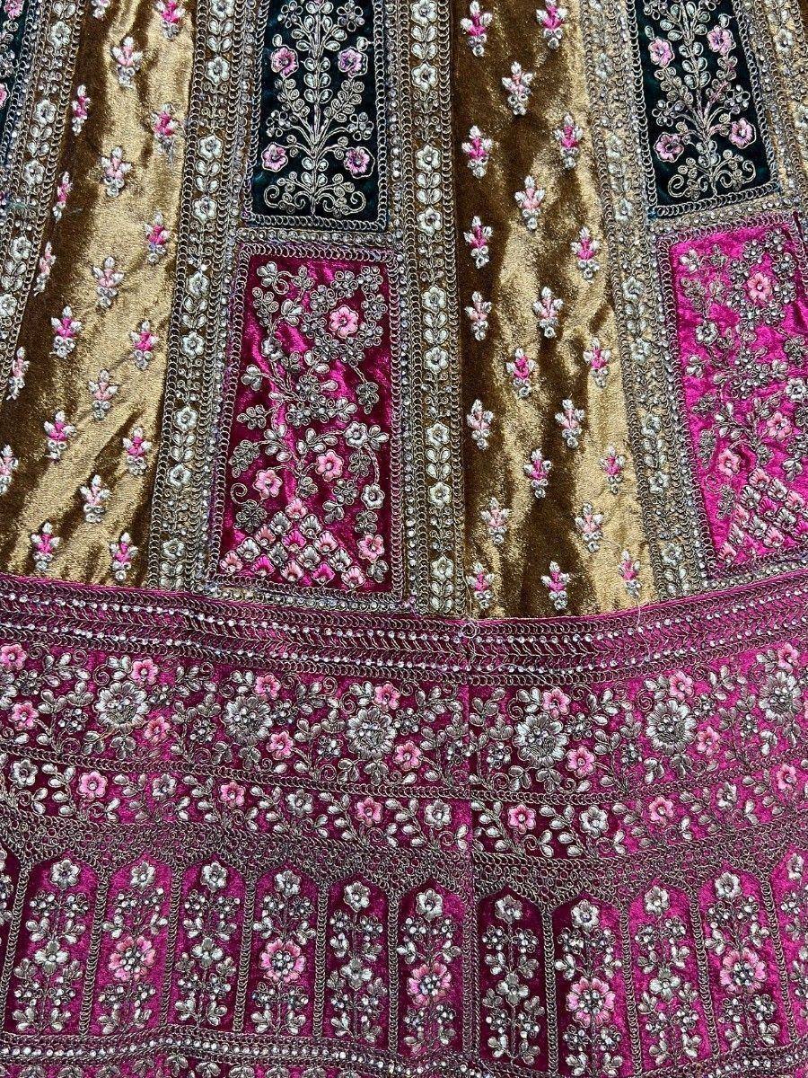 Luxury velvet lehenga with intricate floral embroidery in gold, pink, and black, perfect for Indian ethnic wear.