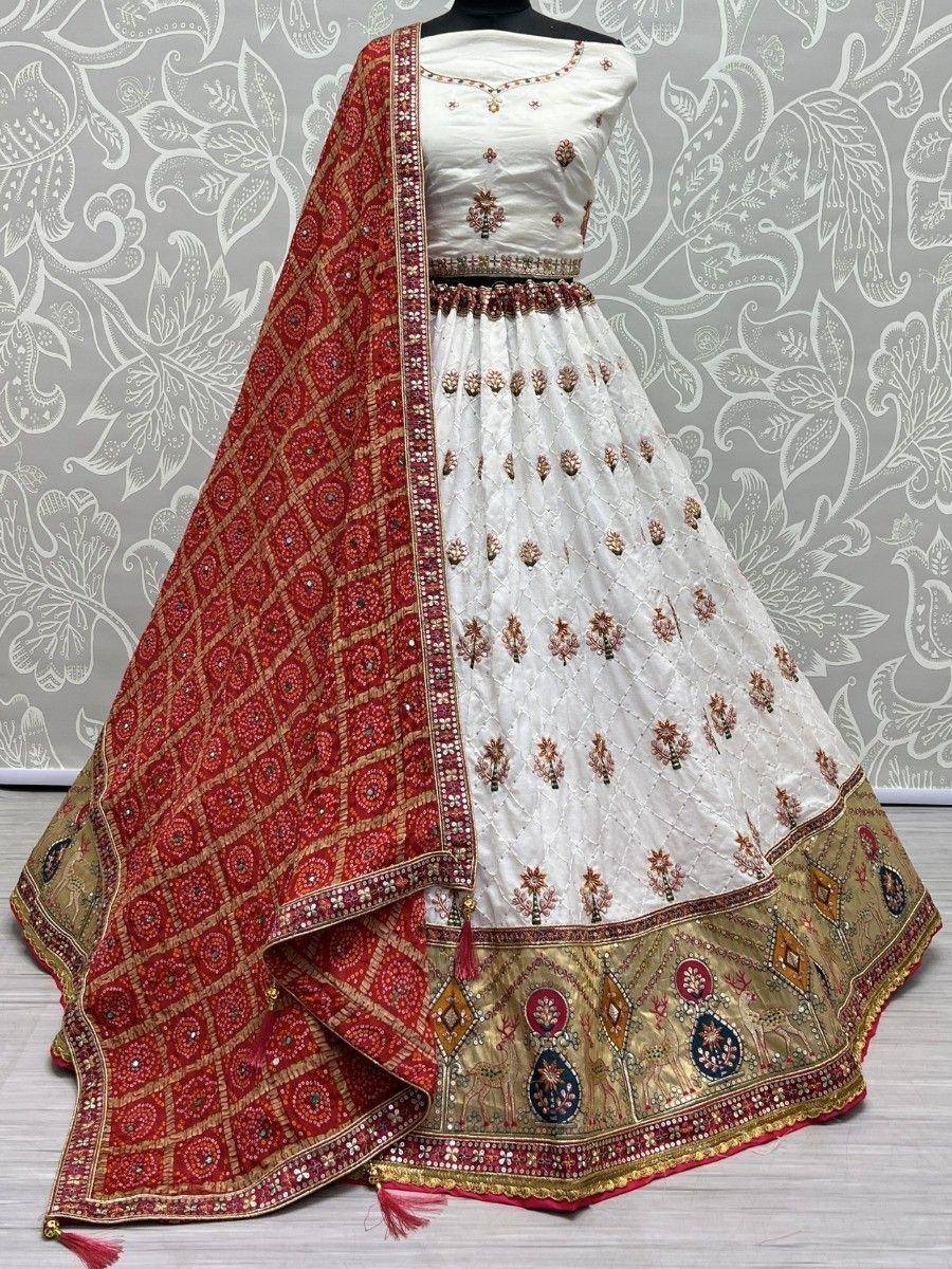White embroidered lehenga choli with red dupatta, ethnic Indian wedding wear