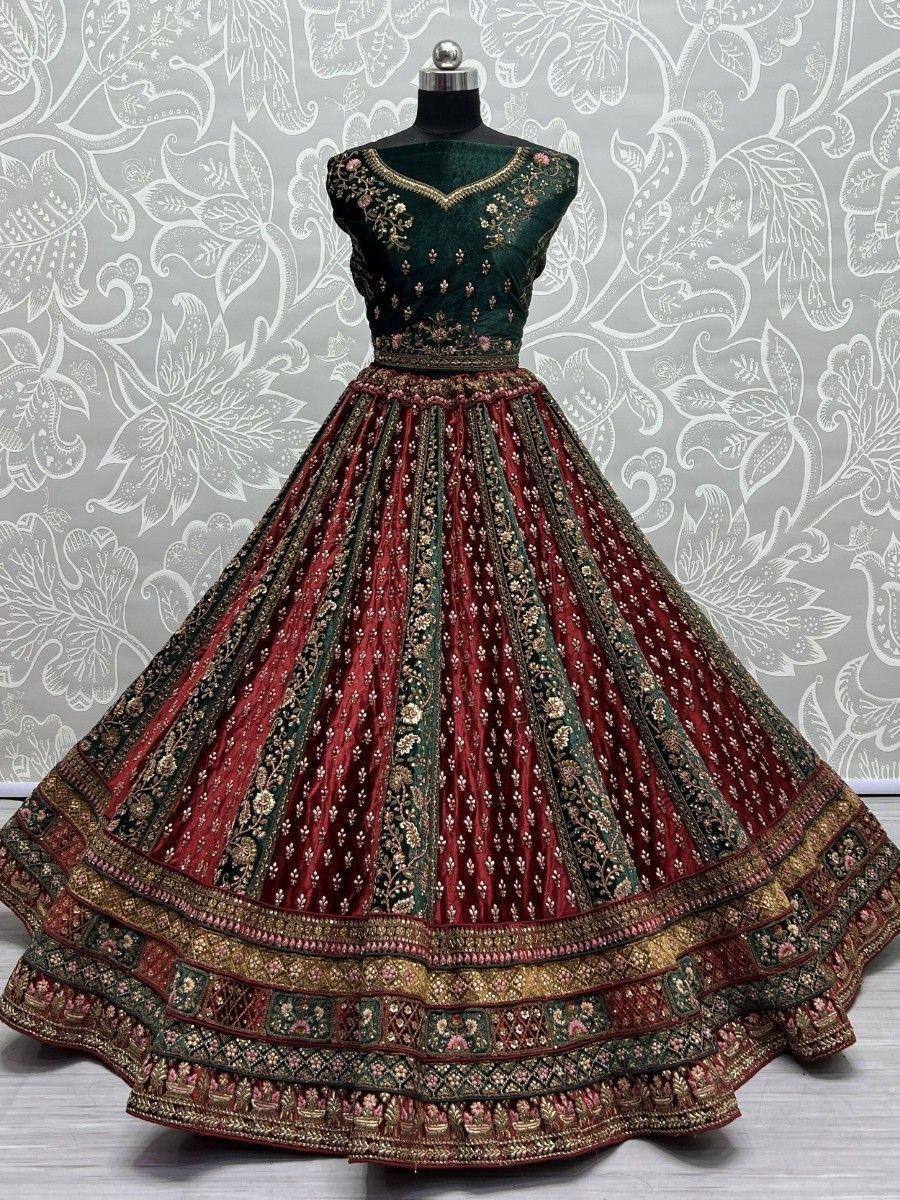 Emerald green and maroon embroidered lehenga choli with floral motifs and heavy border detailing