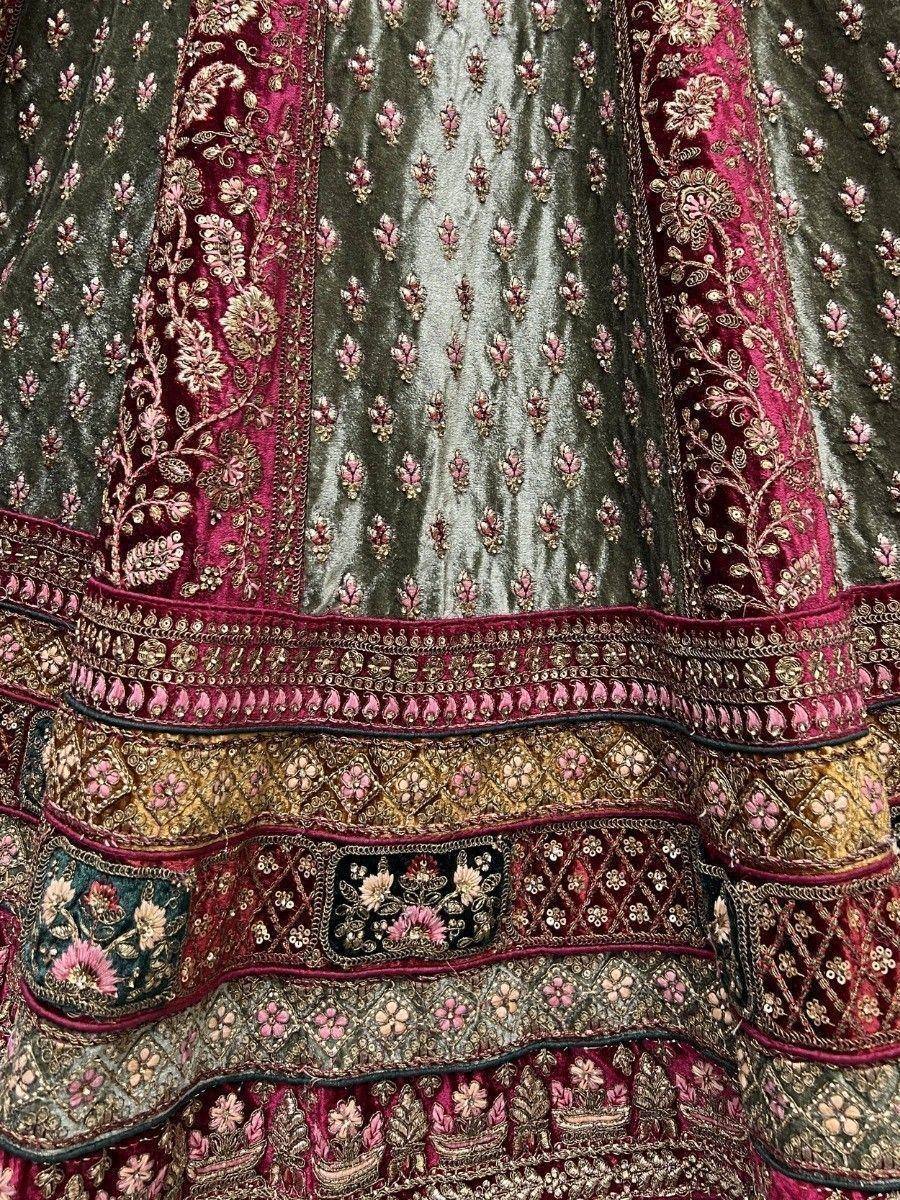 Luxury Indian lehenga with intricate floral embroidery, velvet fabric, and rich maroon-gold detailing for weddings