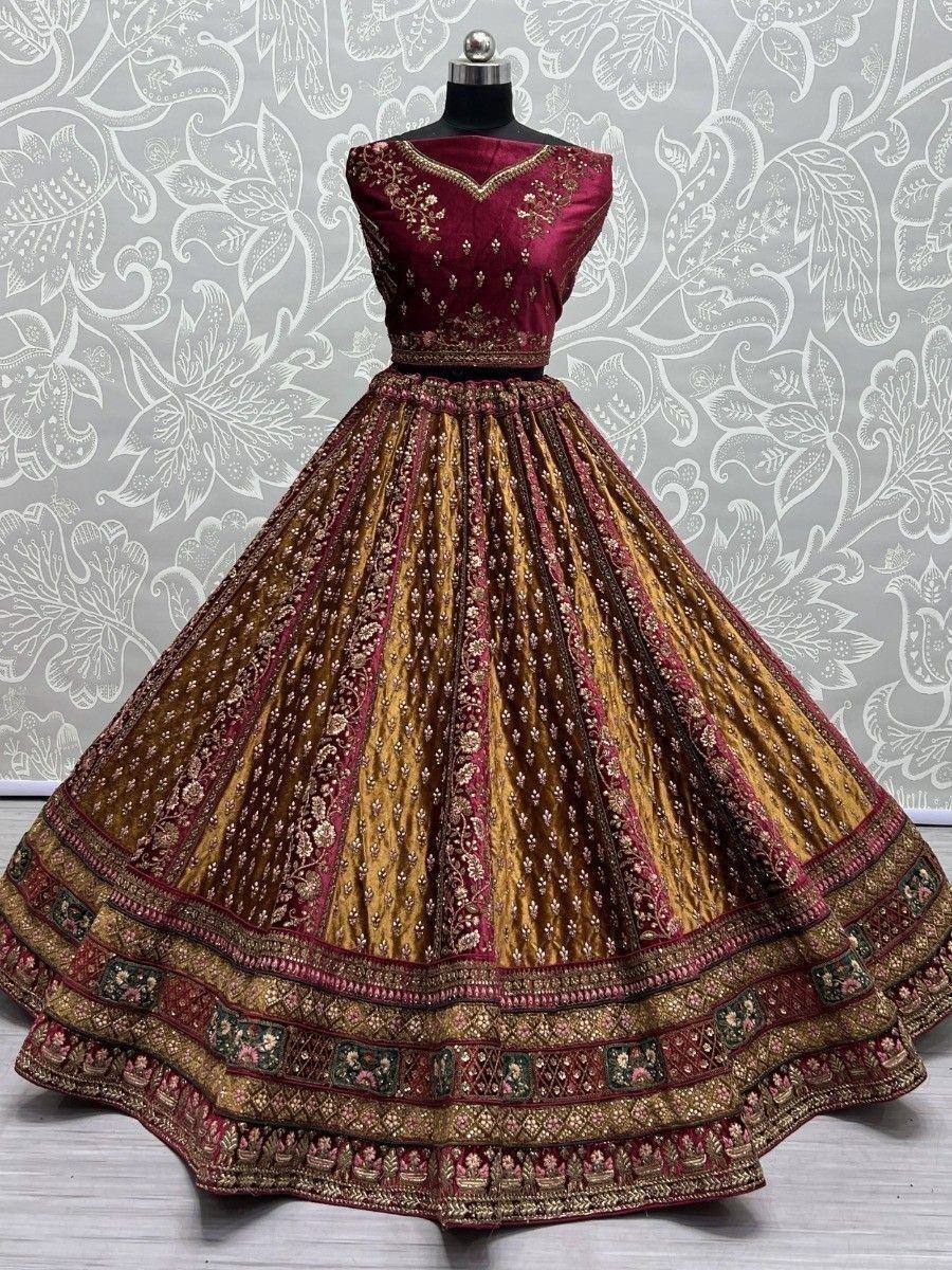 Maroon and gold embroidered lehenga choli with intricate floral patterns and heavy border detailing