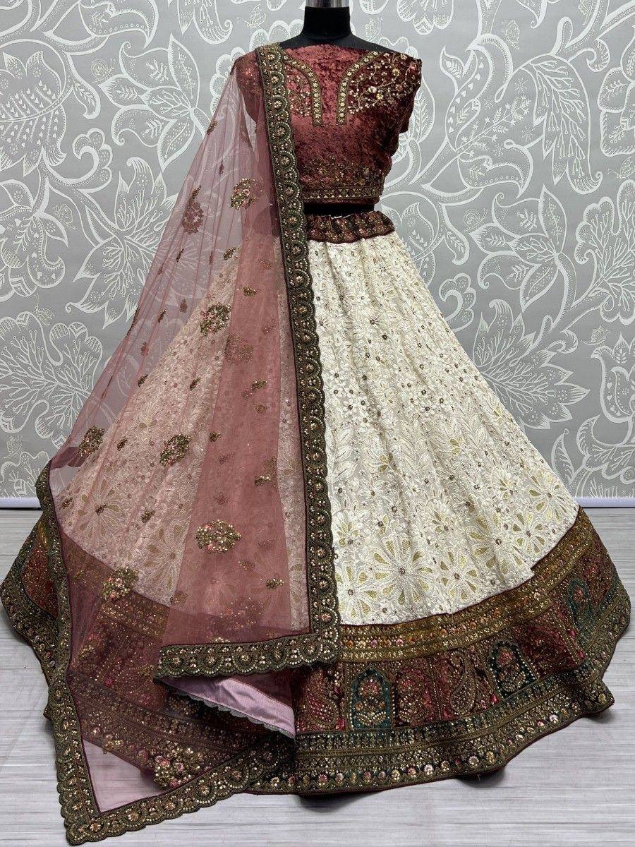 Elegant maroon and cream designer lehenga choli with embroidered dupatta, perfect for Indian weddings and festive occasions.