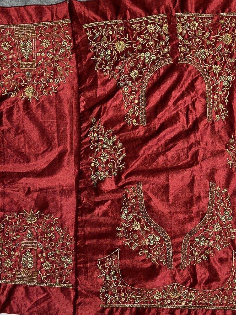 Rich maroon velvet lehenga choli with intricate gold floral embroidery, perfect for Indian ethnic wear.