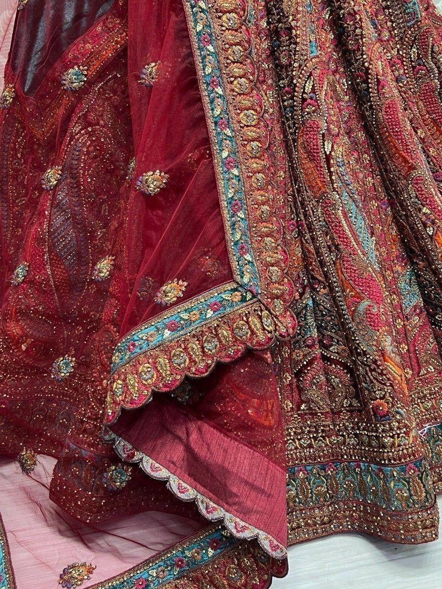 Rich maroon lehenga choli with intricate gold and turquoise embroidery, perfect for Indian ethnic wear.