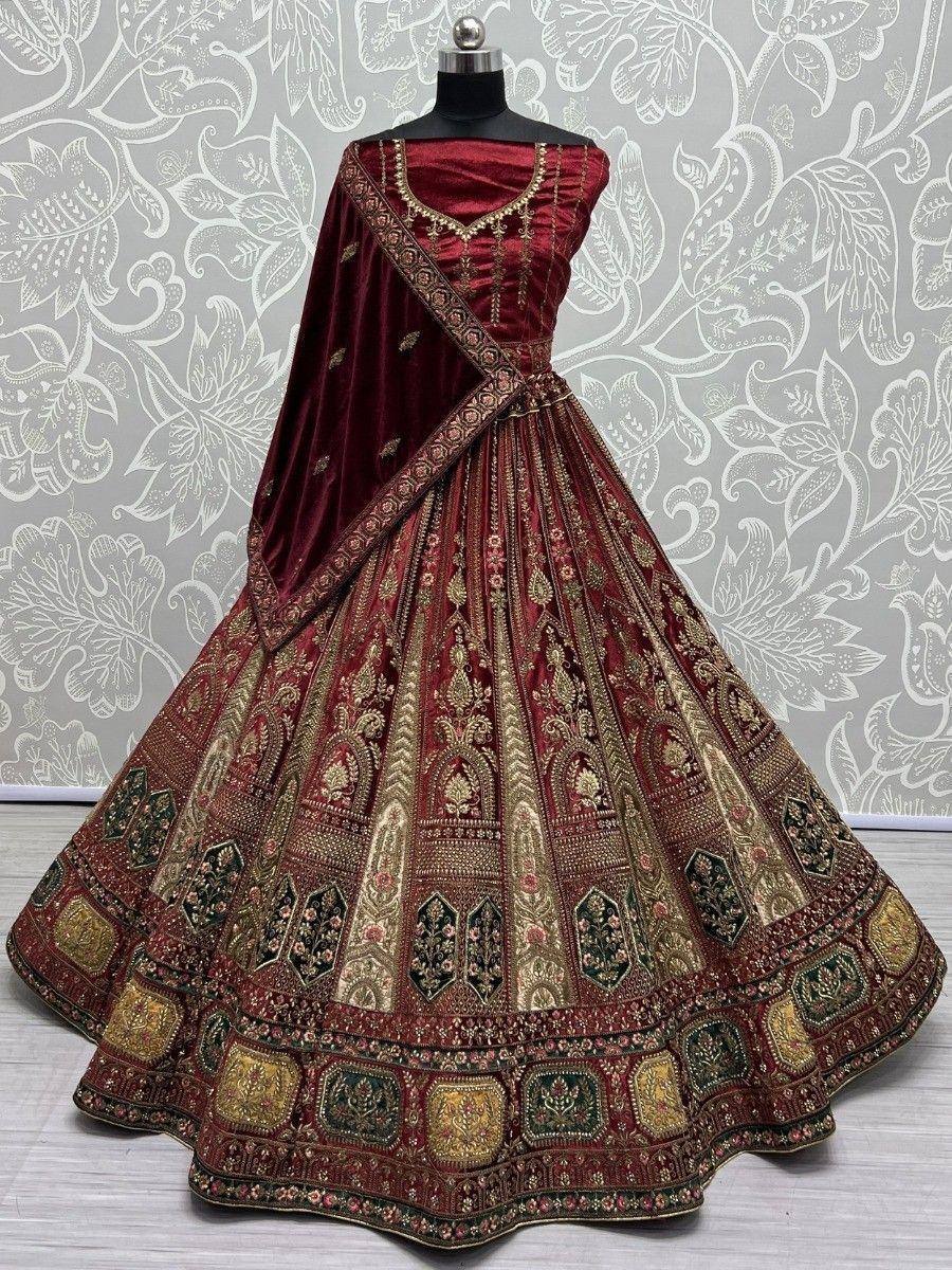 Maroon velvet lehenga choli with gold embroidery, perfect for Indian weddings and festive occasions.