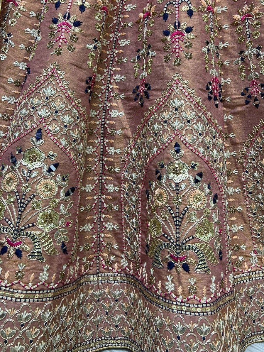 Luxury Indian ethnic lehenga with intricate floral embroidery and mirror work in pink and gold tones