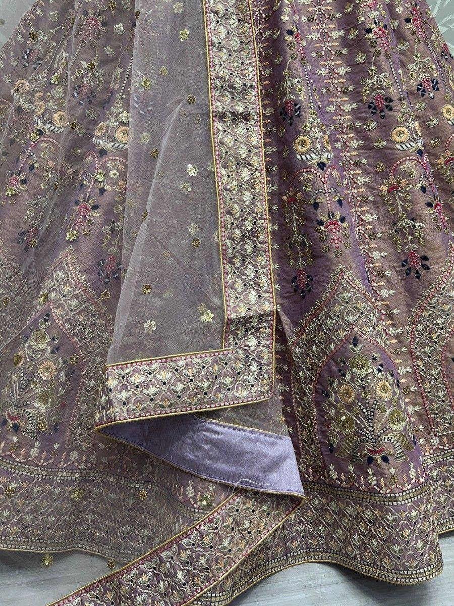 Purple designer lehenga choli with intricate gold and floral embroidery, perfect for Indian ethnic wear.
