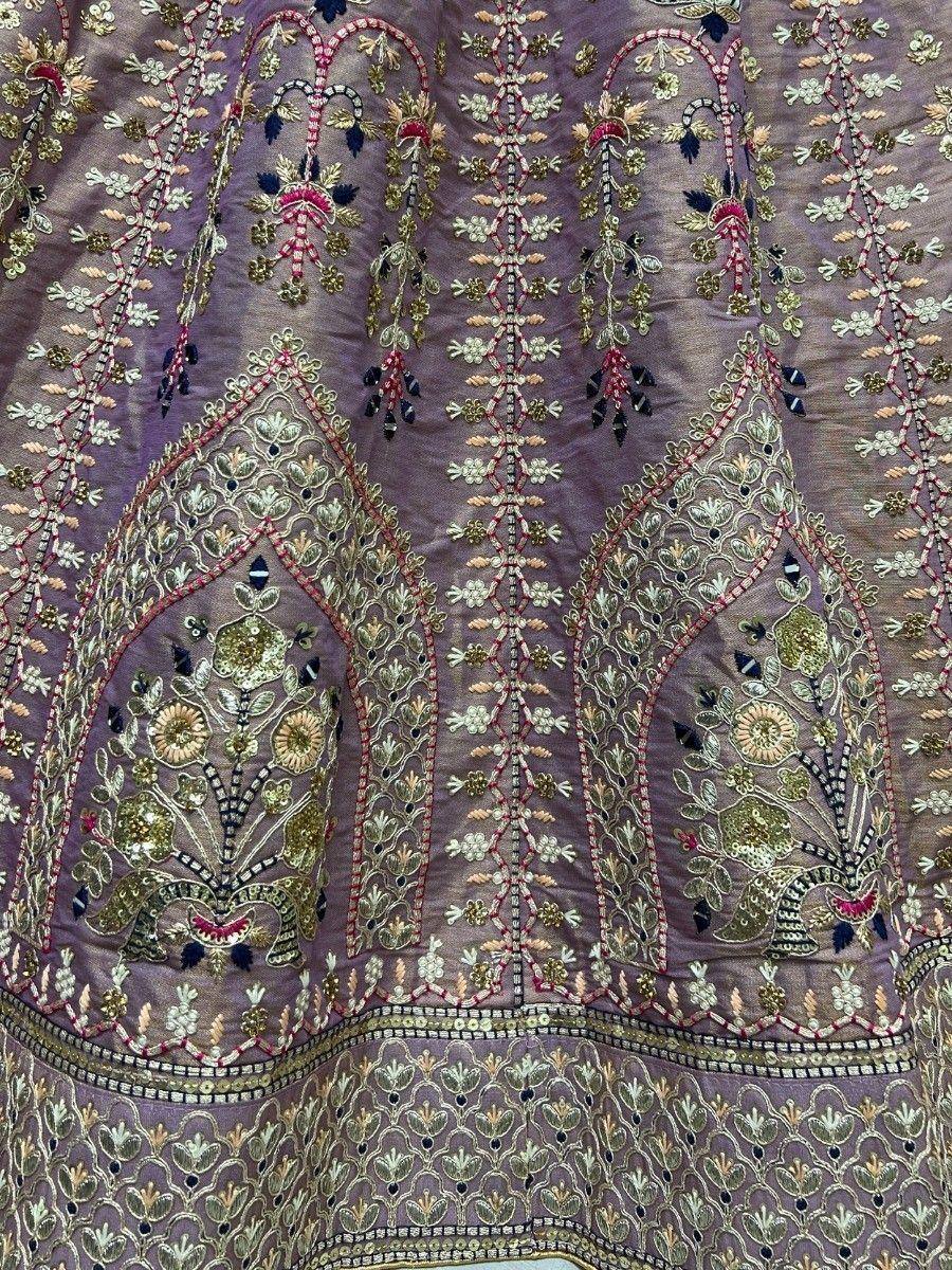 Lavish floral embroidery on purple Indian ethnic wear with gold and pink threadwork