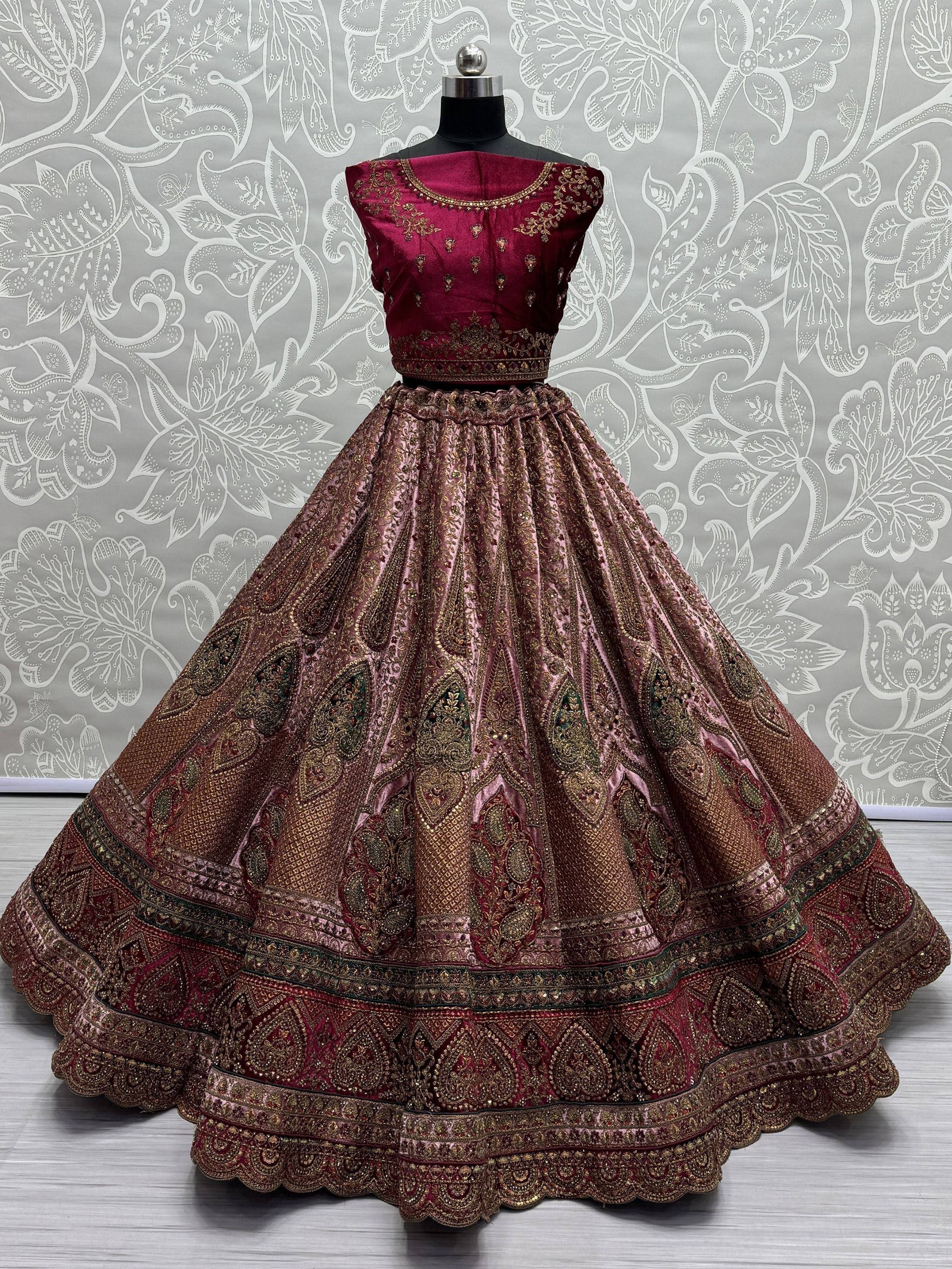 Maroon designer lehenga choli with gold embroidery, perfect for Indian weddings and festive occasions.