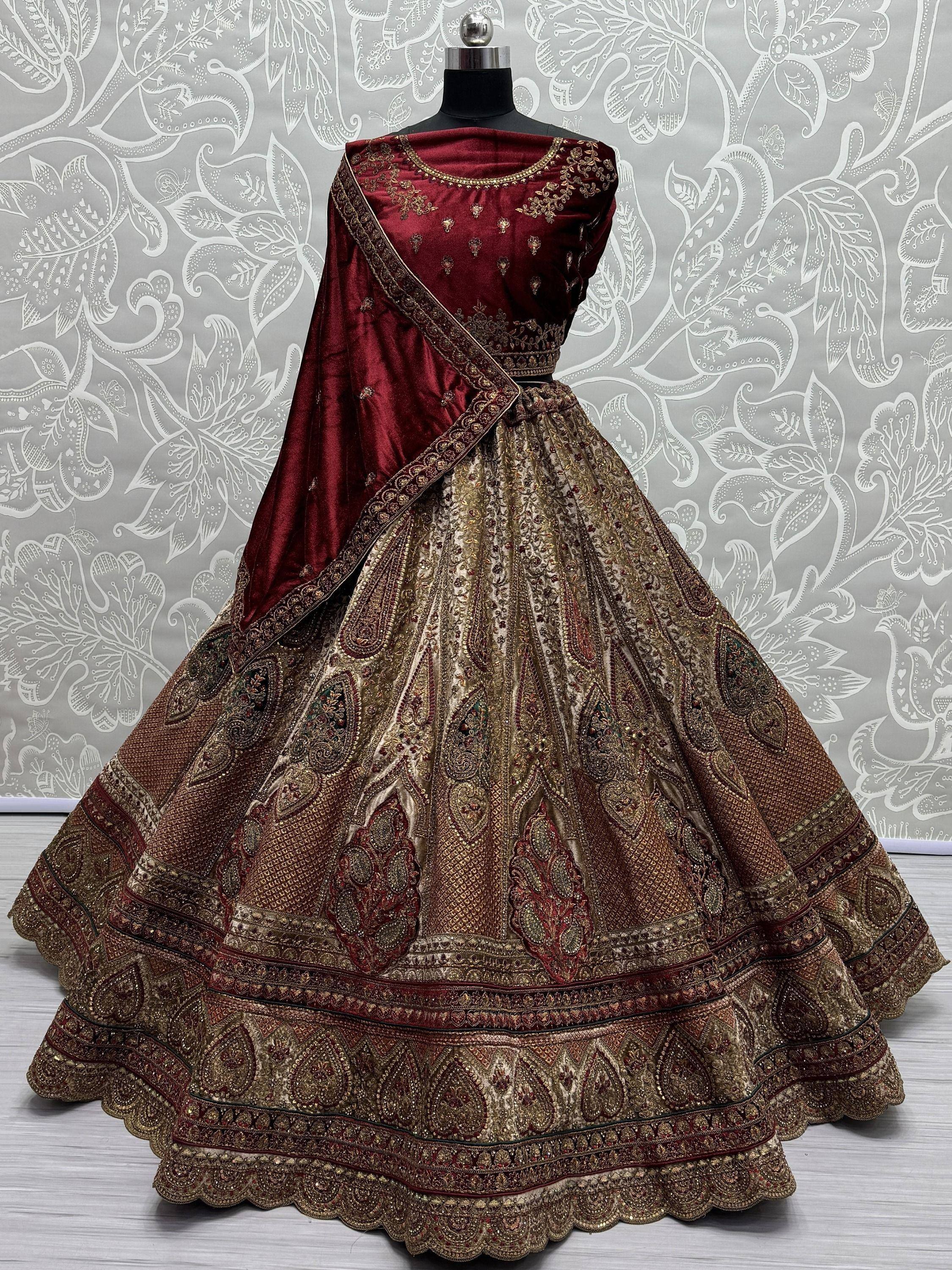 Maroon and gold embroidered lehenga choli with intricate paisley design, perfect for Indian weddings and festive occasions.