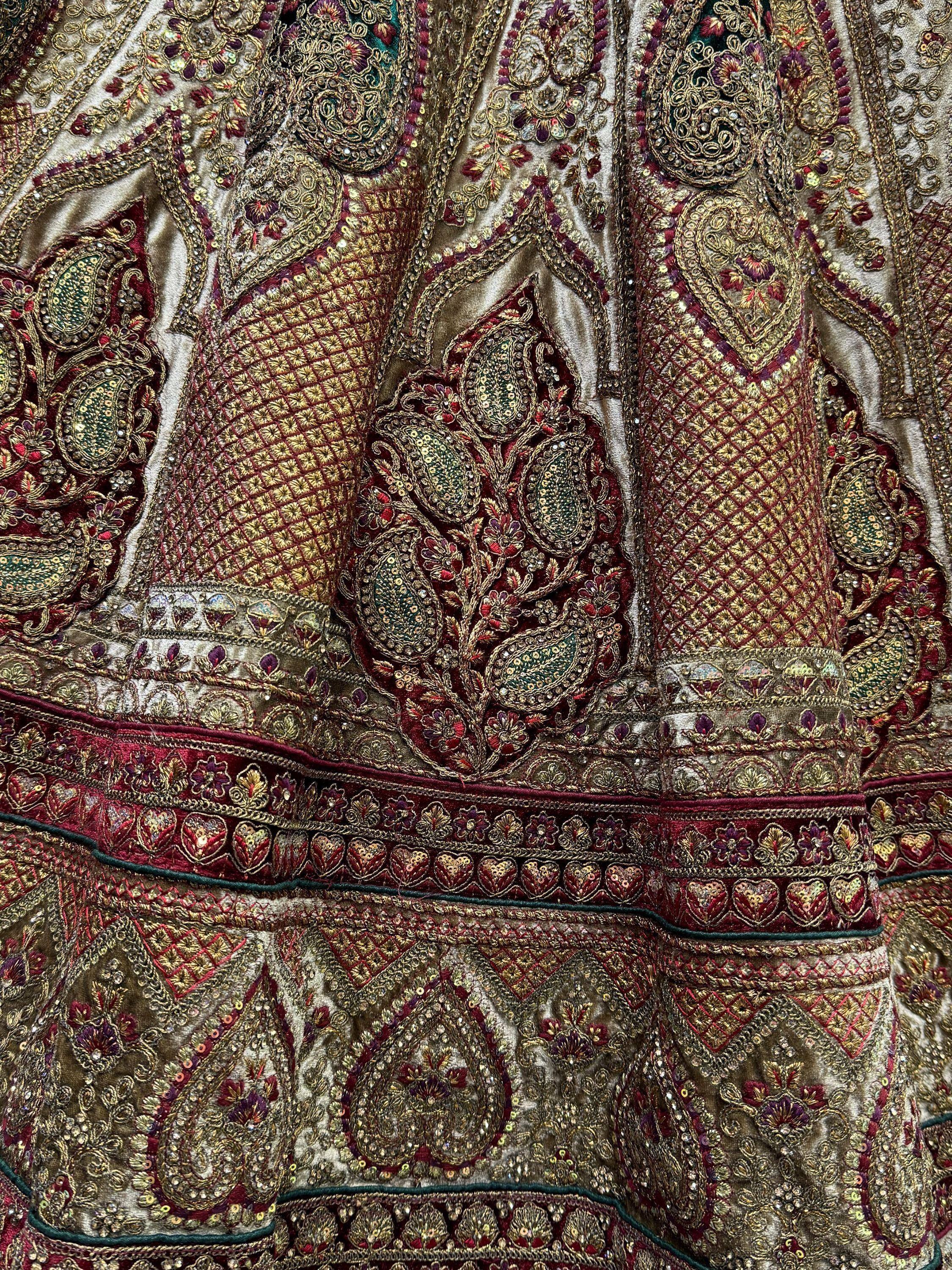 Luxury Indian ethnic wear with intricate gold embroidery, sequins, and paisley motifs on rich velvet fabric.